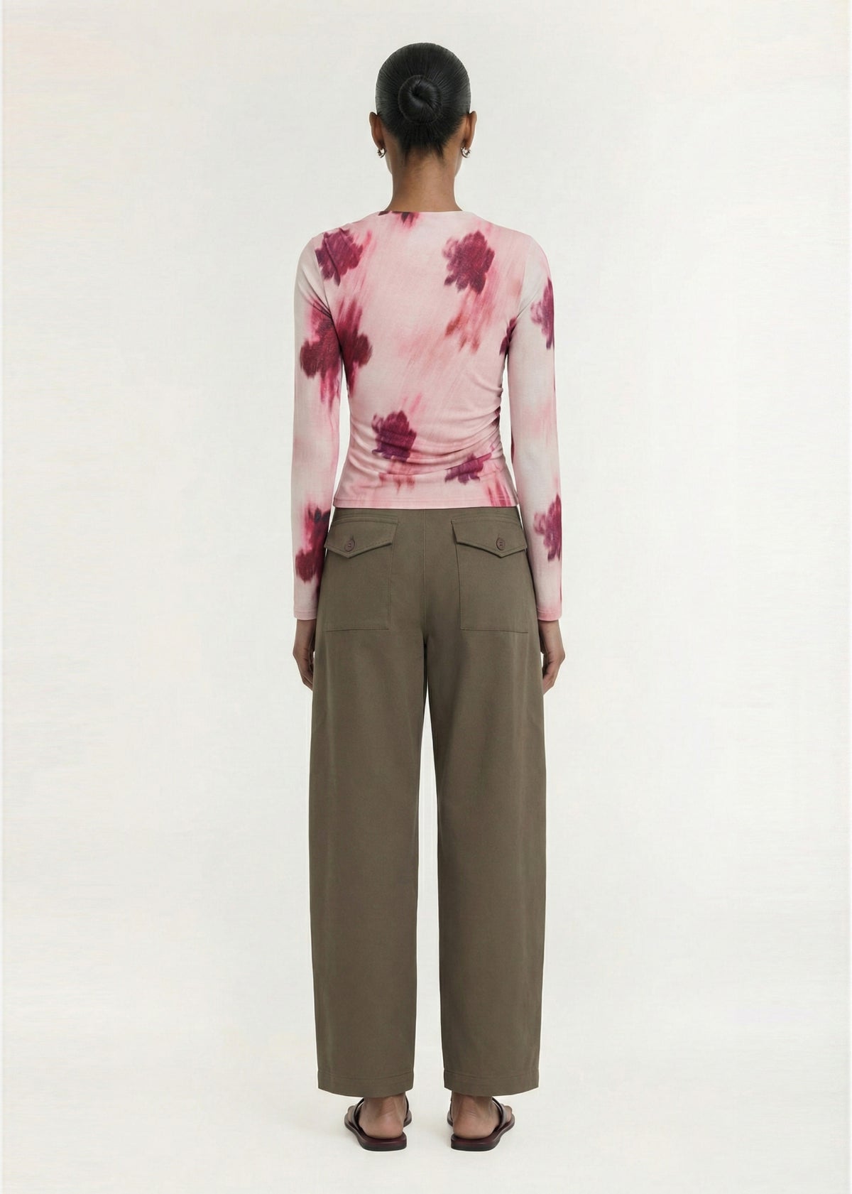 Back view of the Pink Floral Mesh Long Sleeve Top with a printed stretch mesh fabrication and an abstract floral print design.