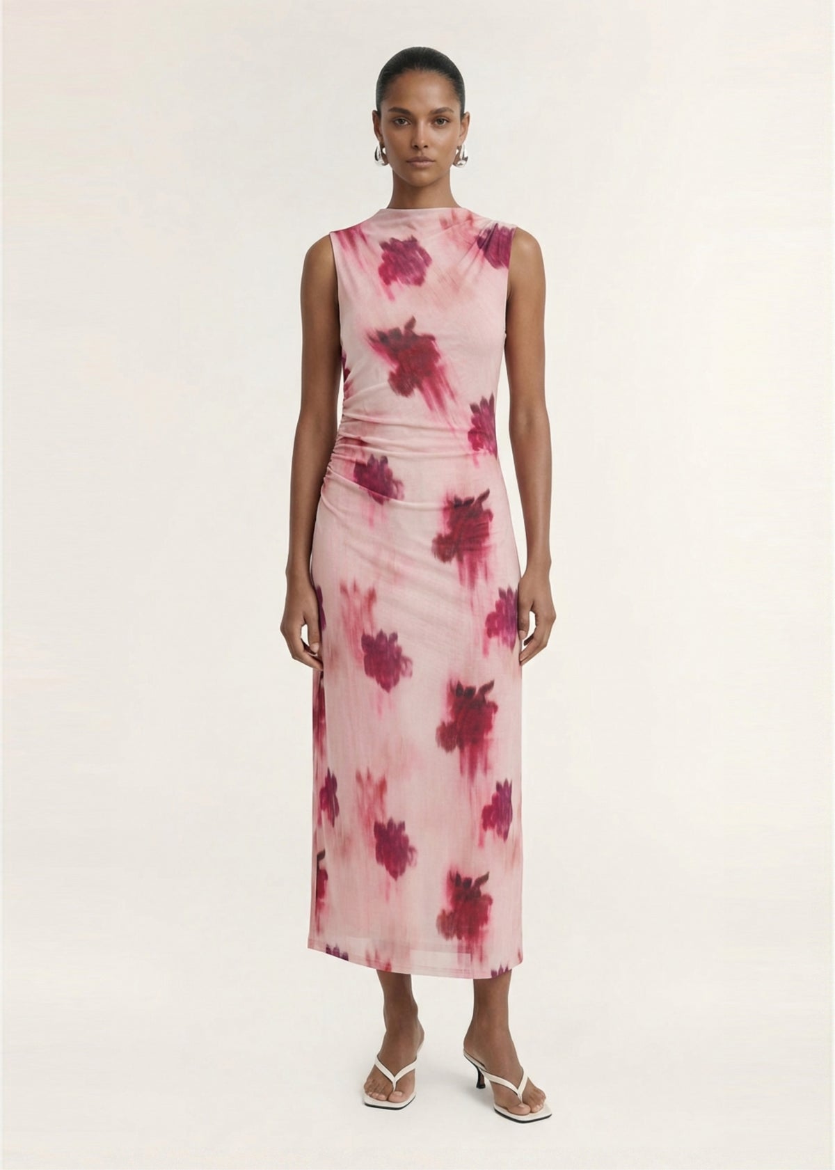 Model wearing Pink Floral Sleeveless Mesh Midi Dress with a printed mesh fabrication and an abstract floral print design.