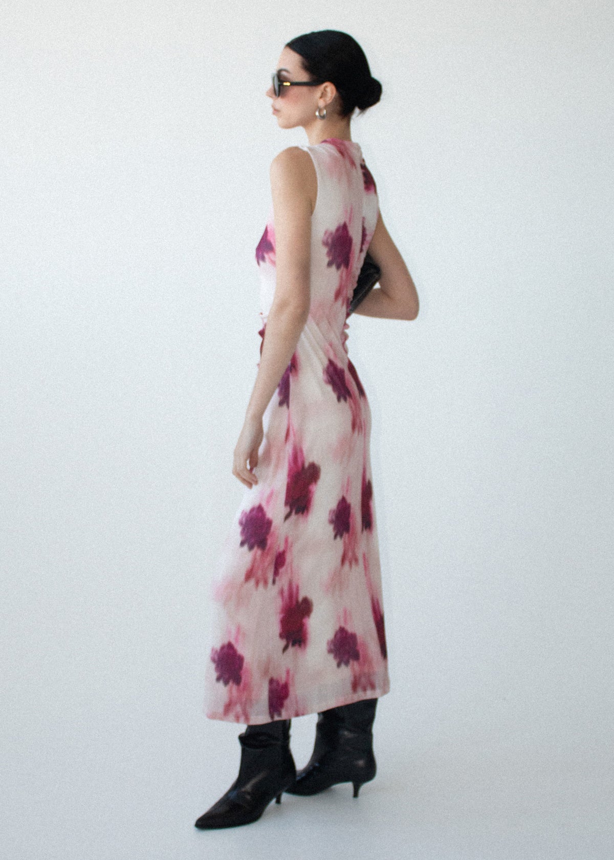 Model wearing Pink Floral Sleeveless Mesh Midi Dress with an invisible back zip closure and a fully lined, turned to the side.