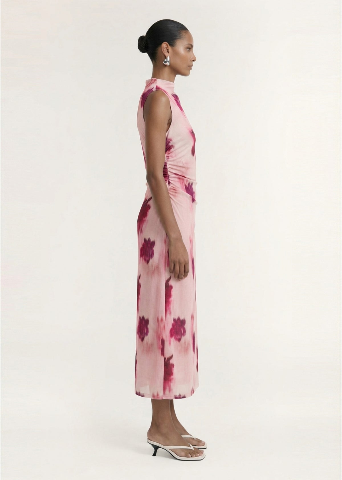 Side view of the Pink Floral Sleeveless Mesh Midi Dress, showing a sleeveless cut and a ruched waist detailing.