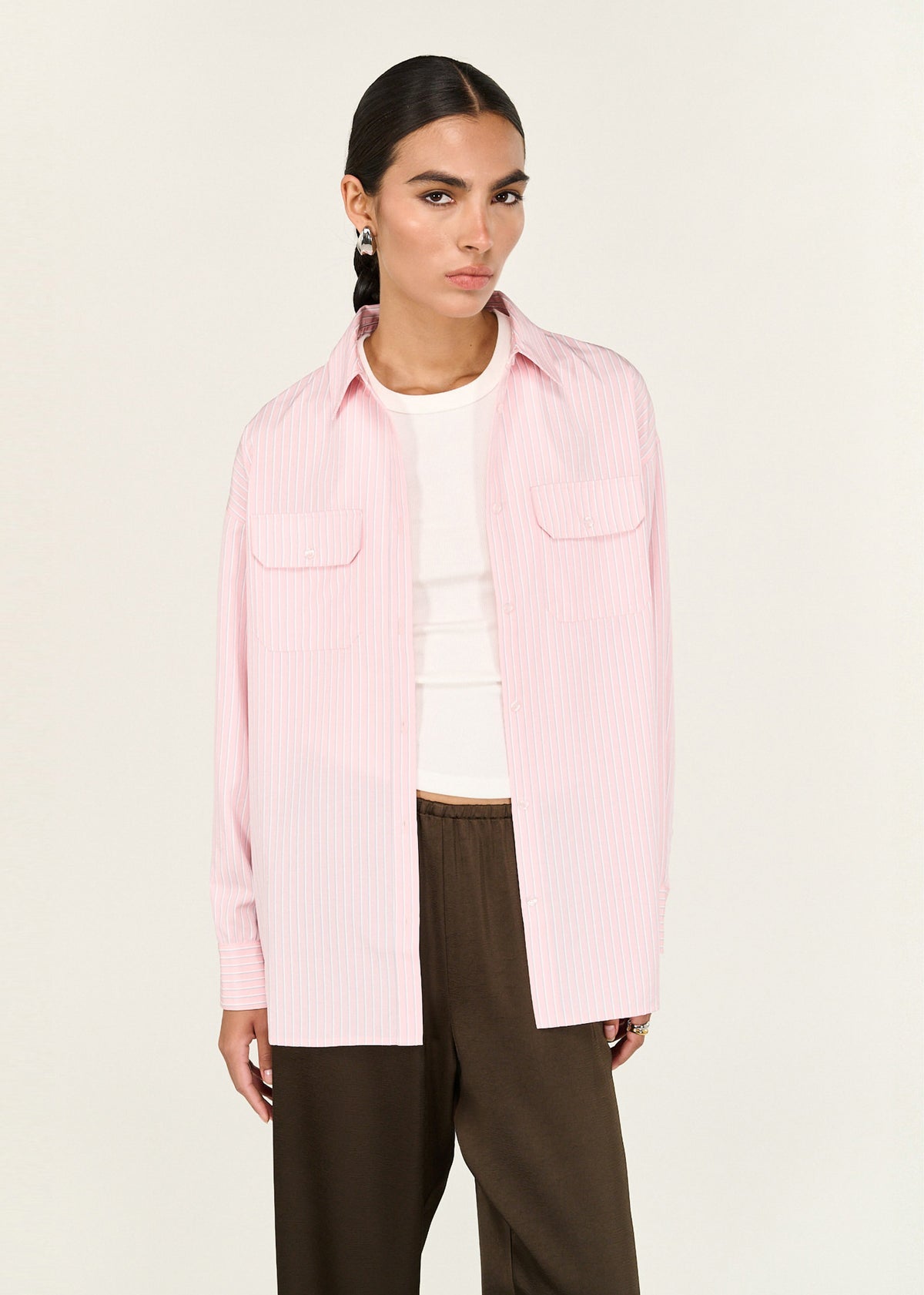 Close-up of the Pink Pinstriped Shirt, showing a classic collar neckline and a button-through front closure.