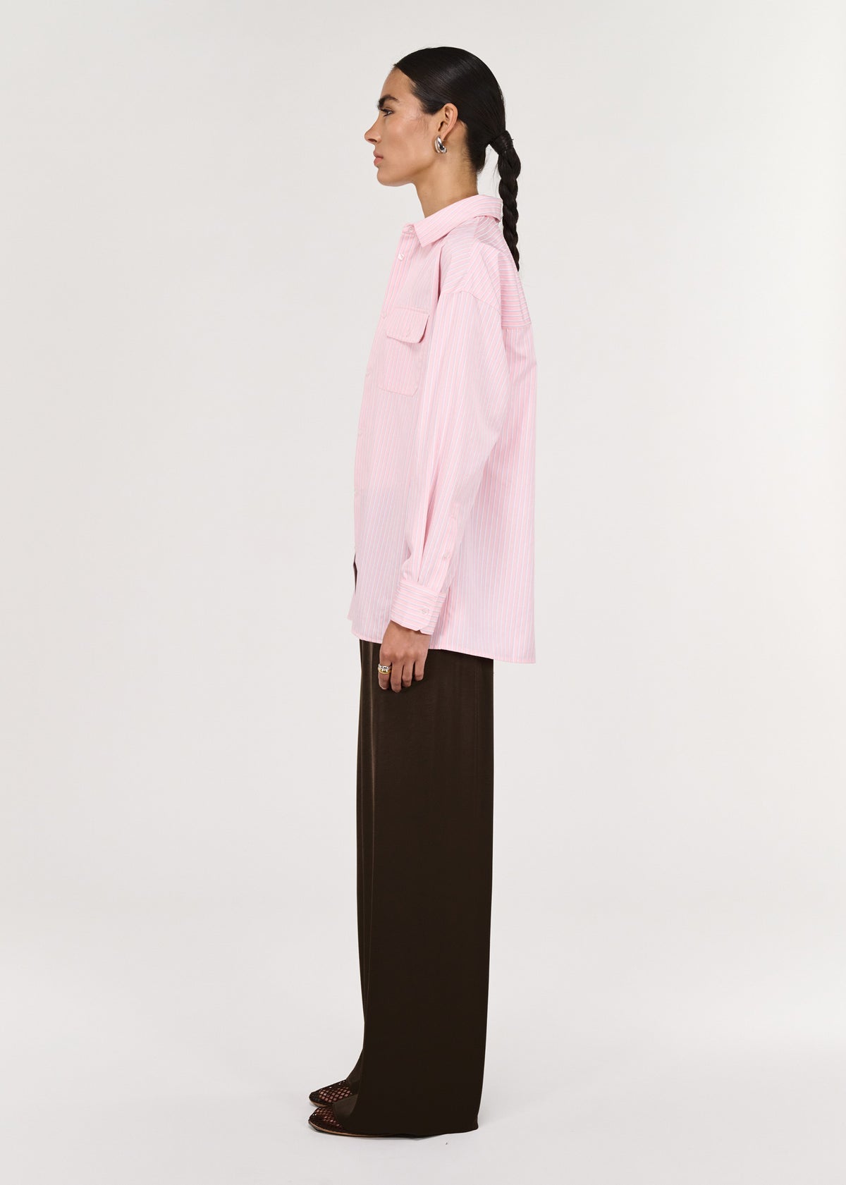 Side view of the Pink Pinstriped Shirt, showing a fine stripe detailing and a lightweight, breathable feel.