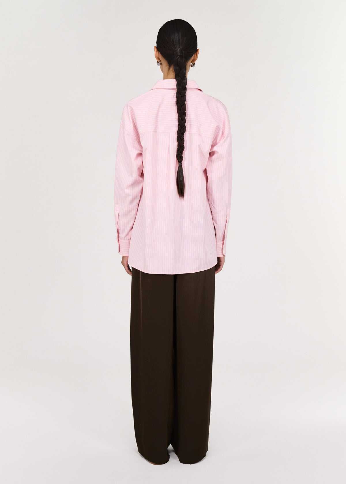 Back view of the Pink Pinstriped Shirt with a button-through front closure and a classic collar neckline.