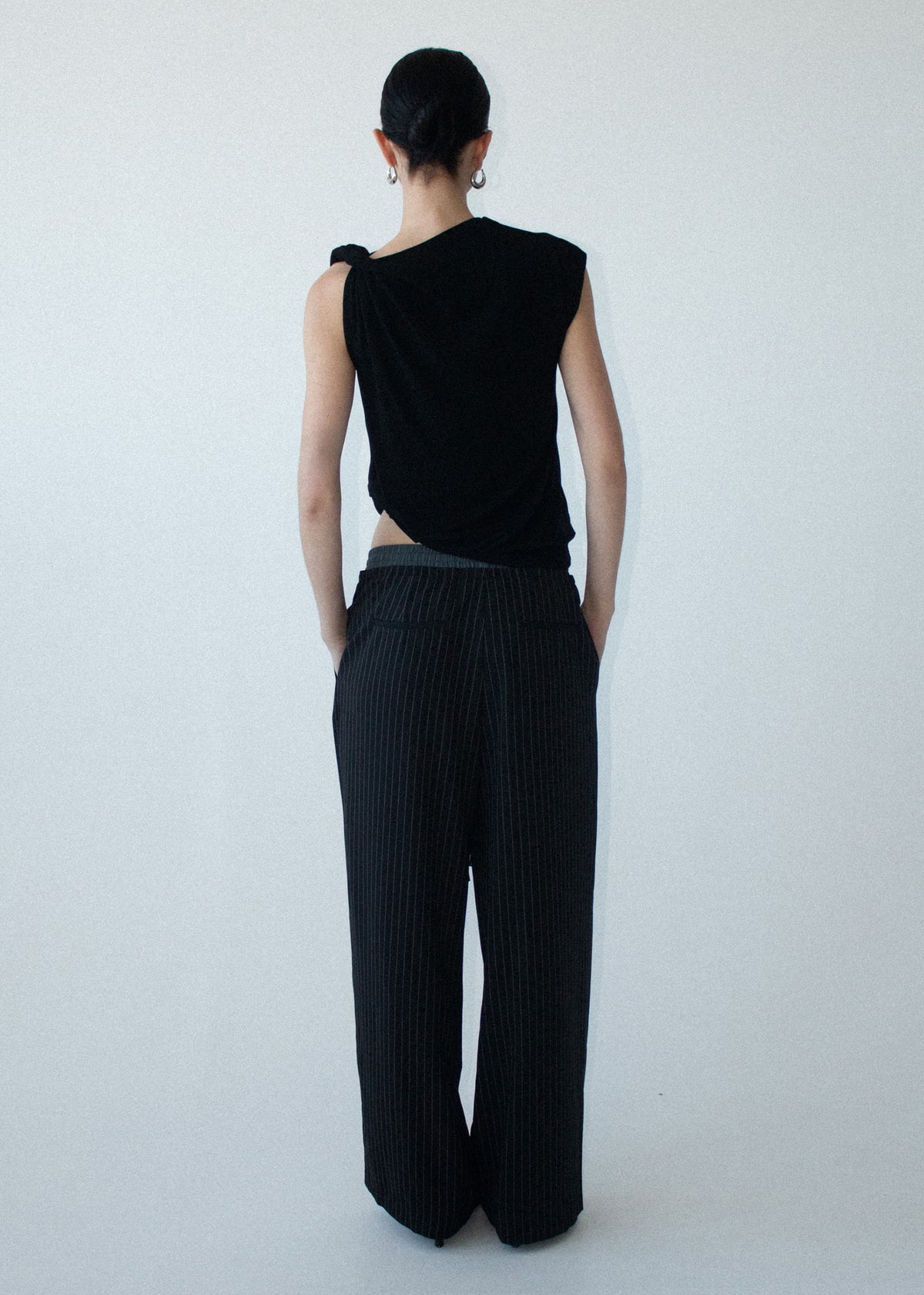 Back view of the Pinstripe Relaxed Drawstring Pants with an adjustable drawcord tie and a soft woven fabrication.