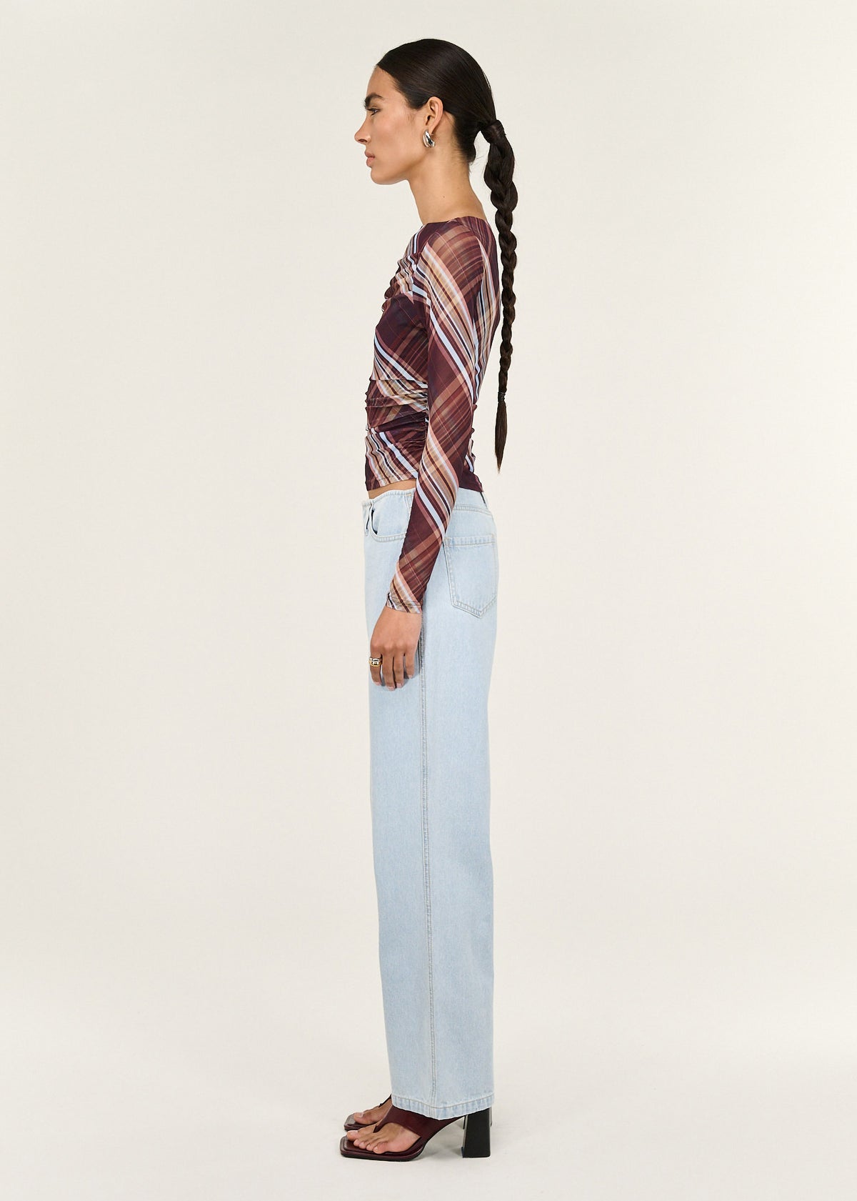 Side view of the Plaid Mesh Boat Neck Top with Gather Detail, showing a soft drape and a sheer mesh fabrication.