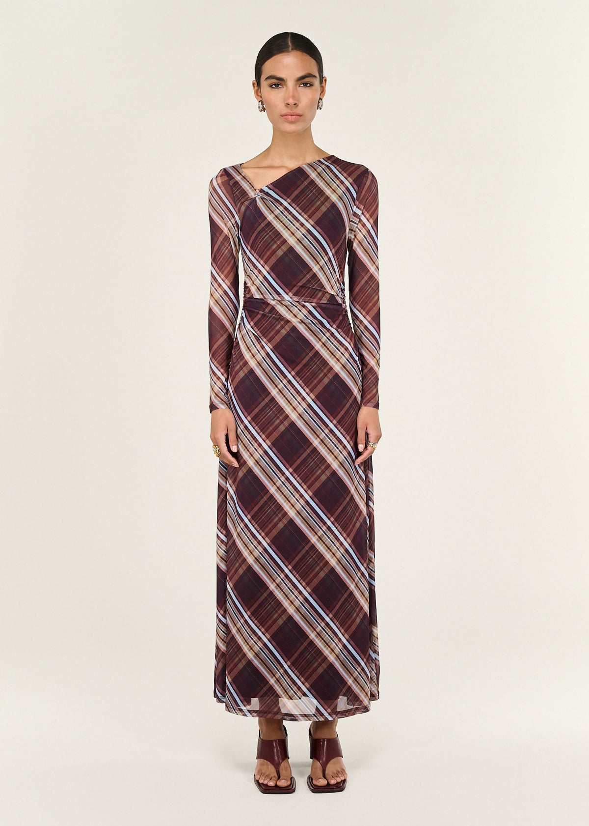 Model wearing Plaid Mesh Long Sleeve Midi Dress with long sleeves and an asymmetric neckline detail.