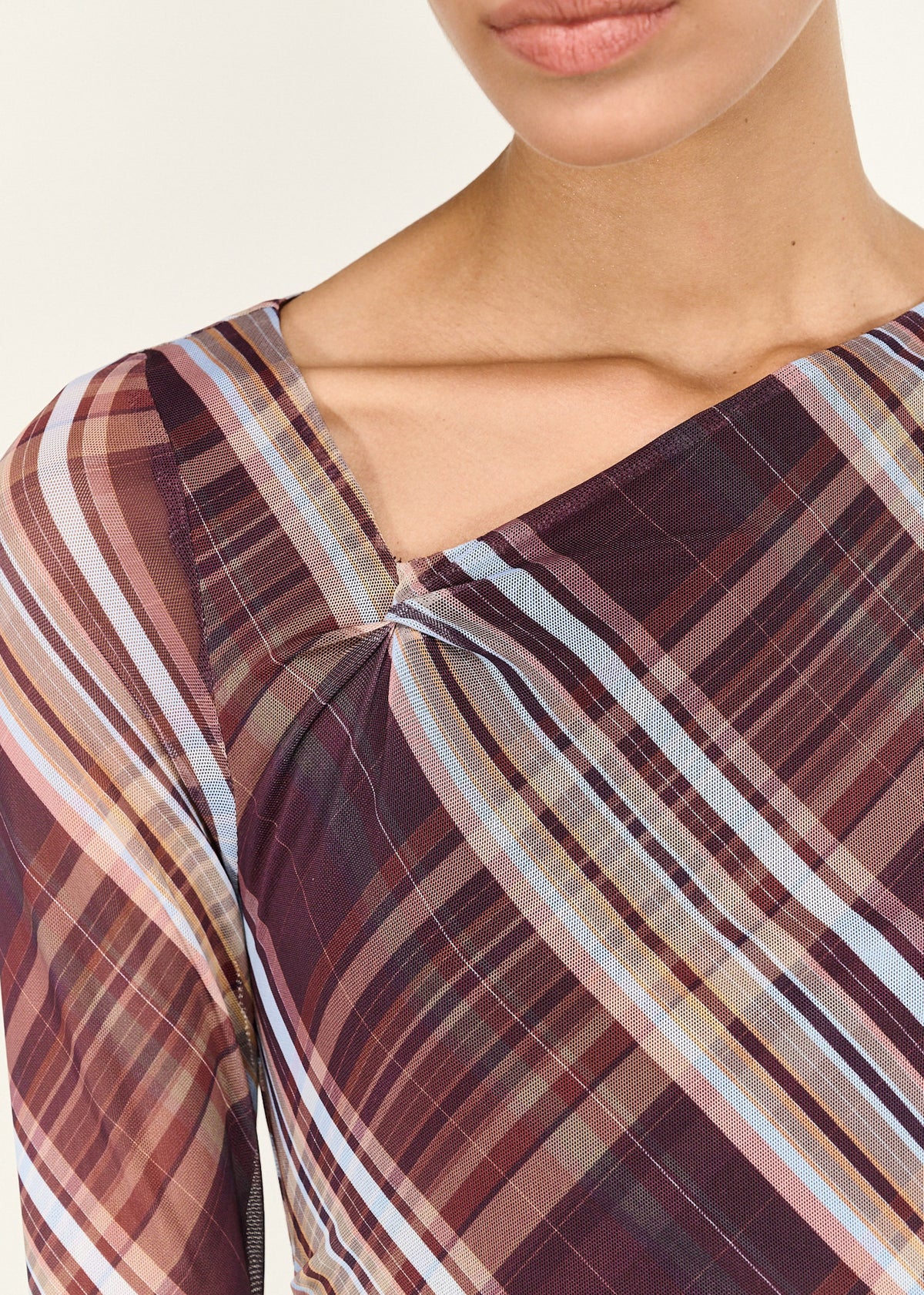 Close-up detail of the Plaid Mesh Long Sleeve Midi Dress, showing twisted neckline.