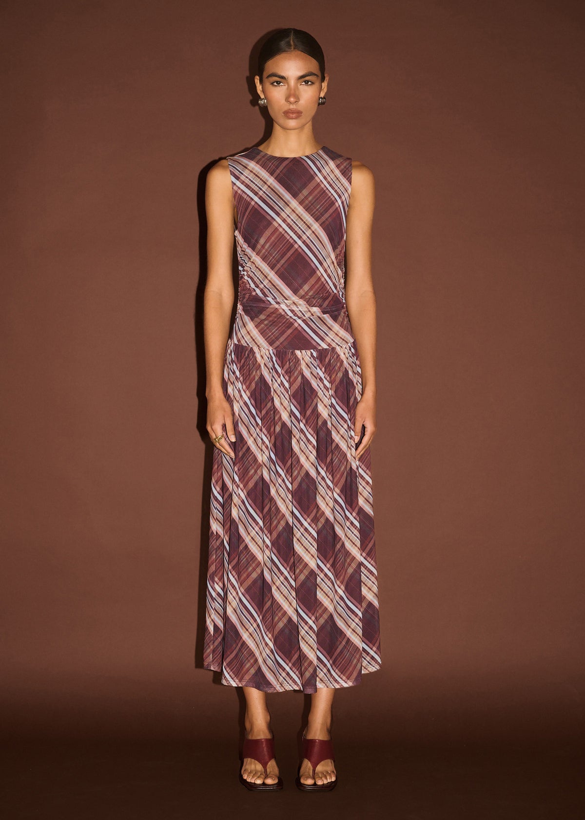 Model wearing Plaid Mesh Midi Dress with Drop Waist with a sleeveless cut and a fitted bodice with drop waist seam.