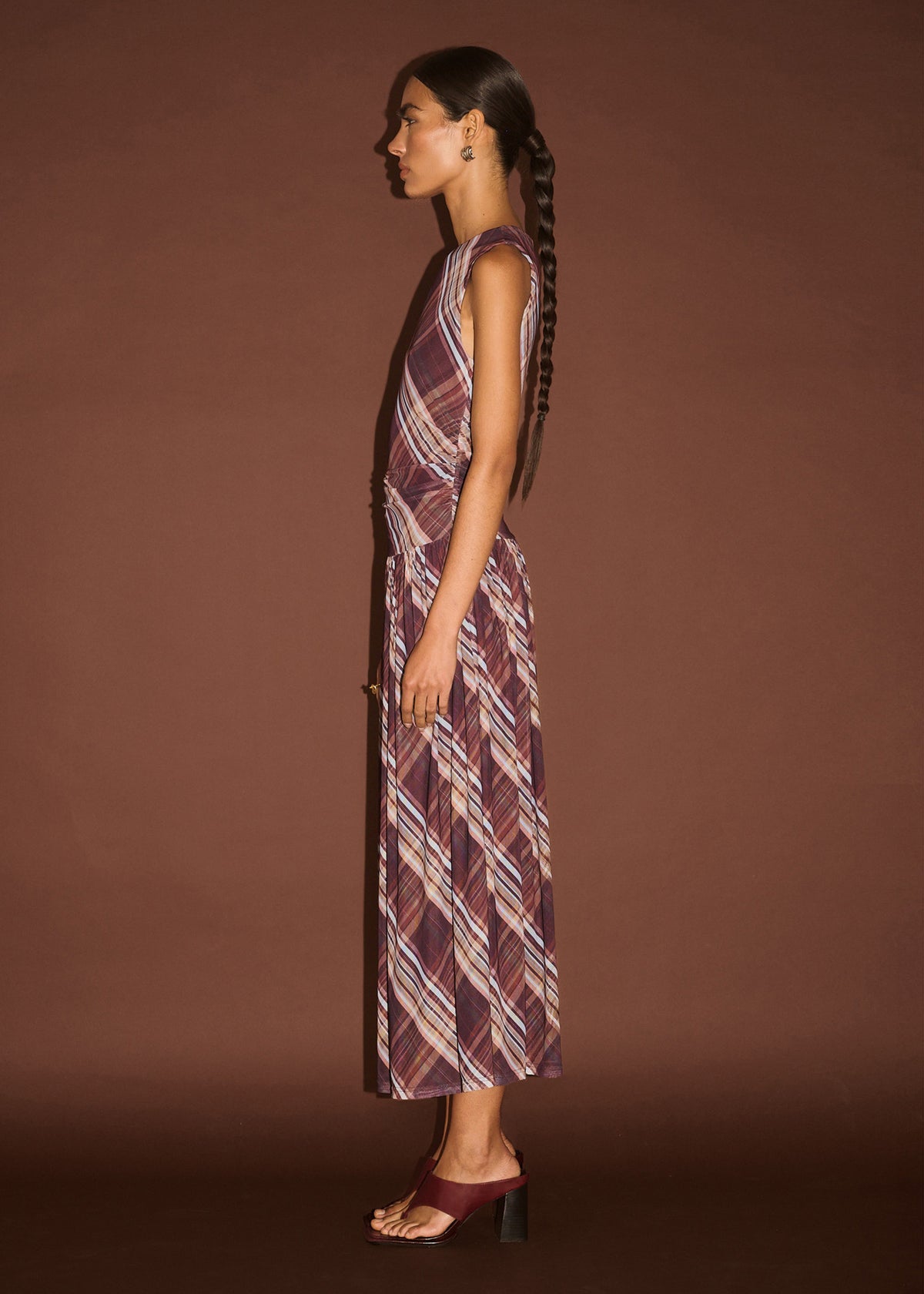 Side view of the Plaid Mesh Midi Dress with Drop Waist, showing a soft drape and a sleeveless cut.