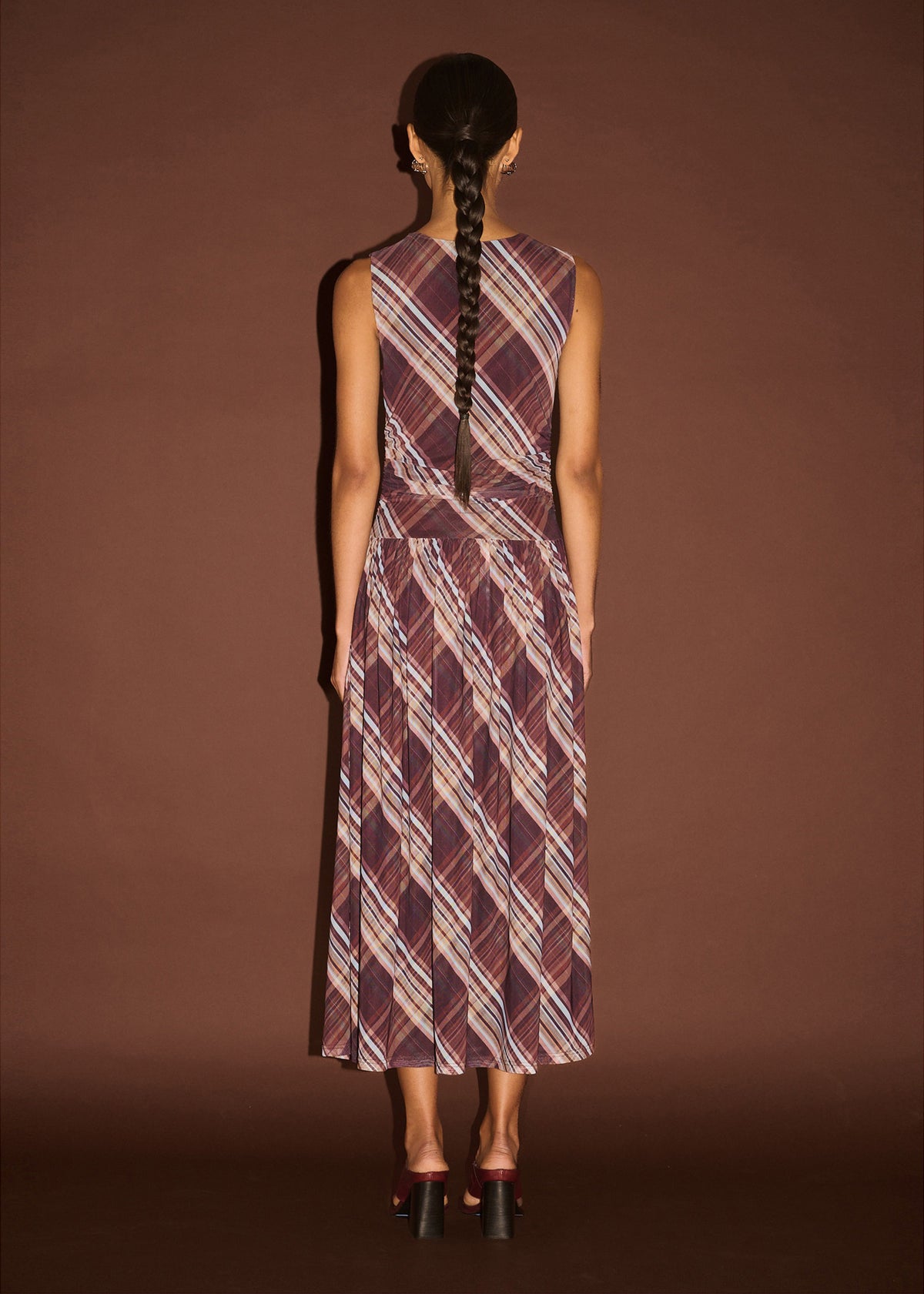 Back view of the Plaid Mesh Midi Dress with Drop Waist with a sleeveless cut and a fitted bodice with drop waist seam.