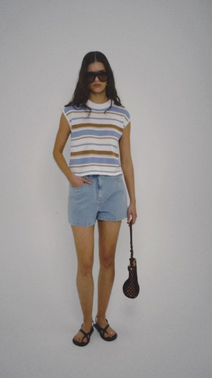 Model wearing a Striped Knit Tank Top paired with denim shorts and accessories.