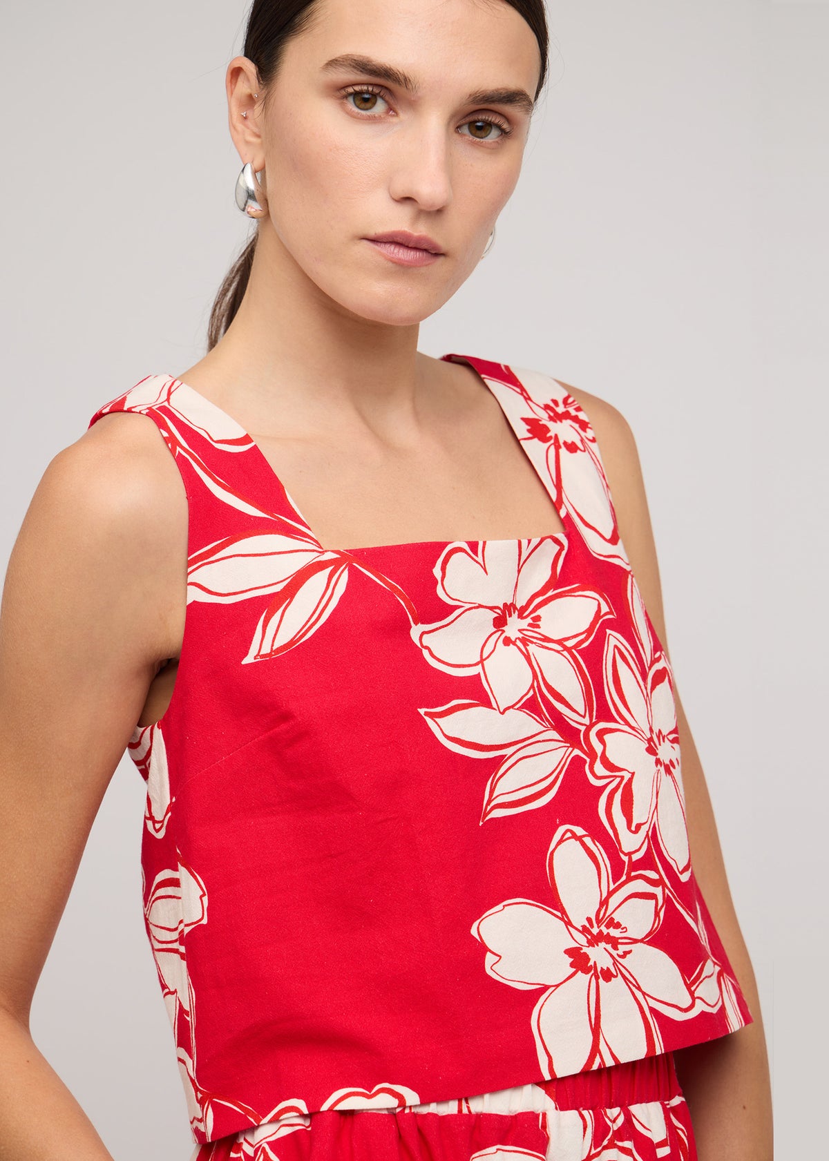 Close-up of the Red and White Cotton Floral A-Line Maxi Skirt, showing a red with white floral print and an elasticated waistband.