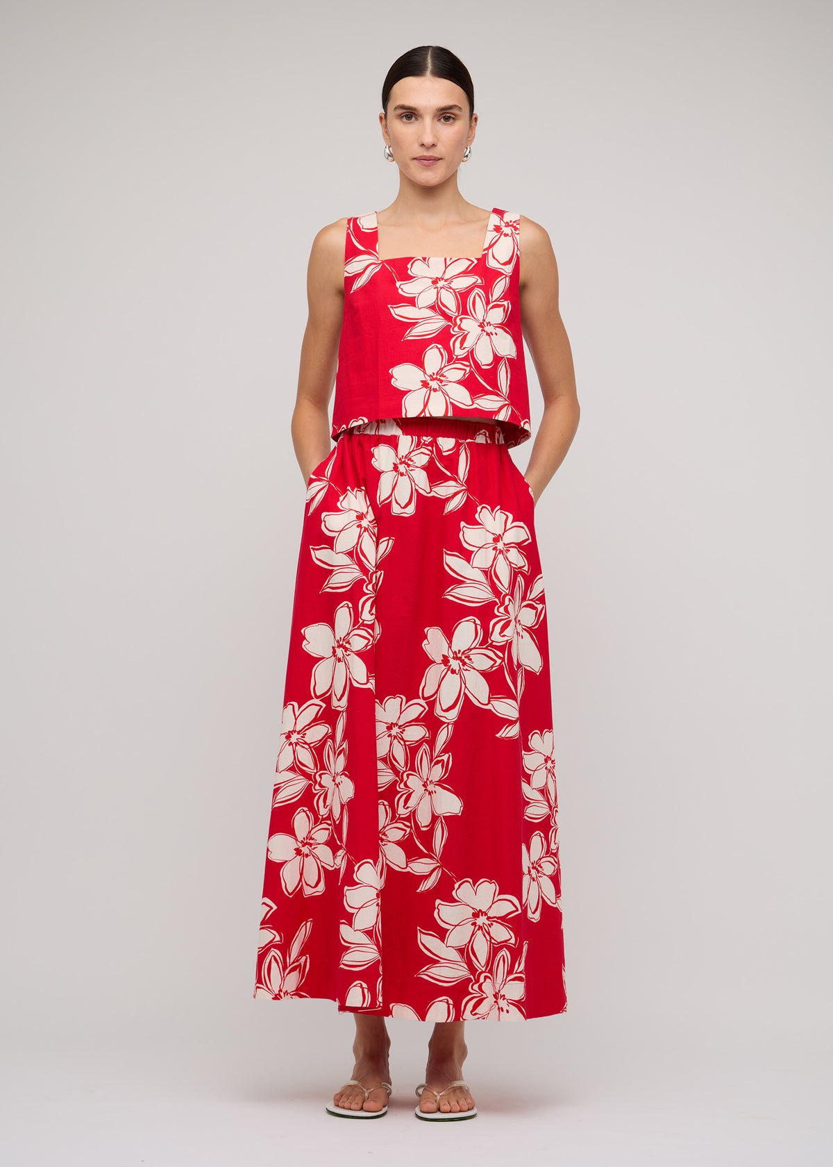 Model wearing Red and White Cotton Floral Crop Top with a red with white floral print and a square neckline.