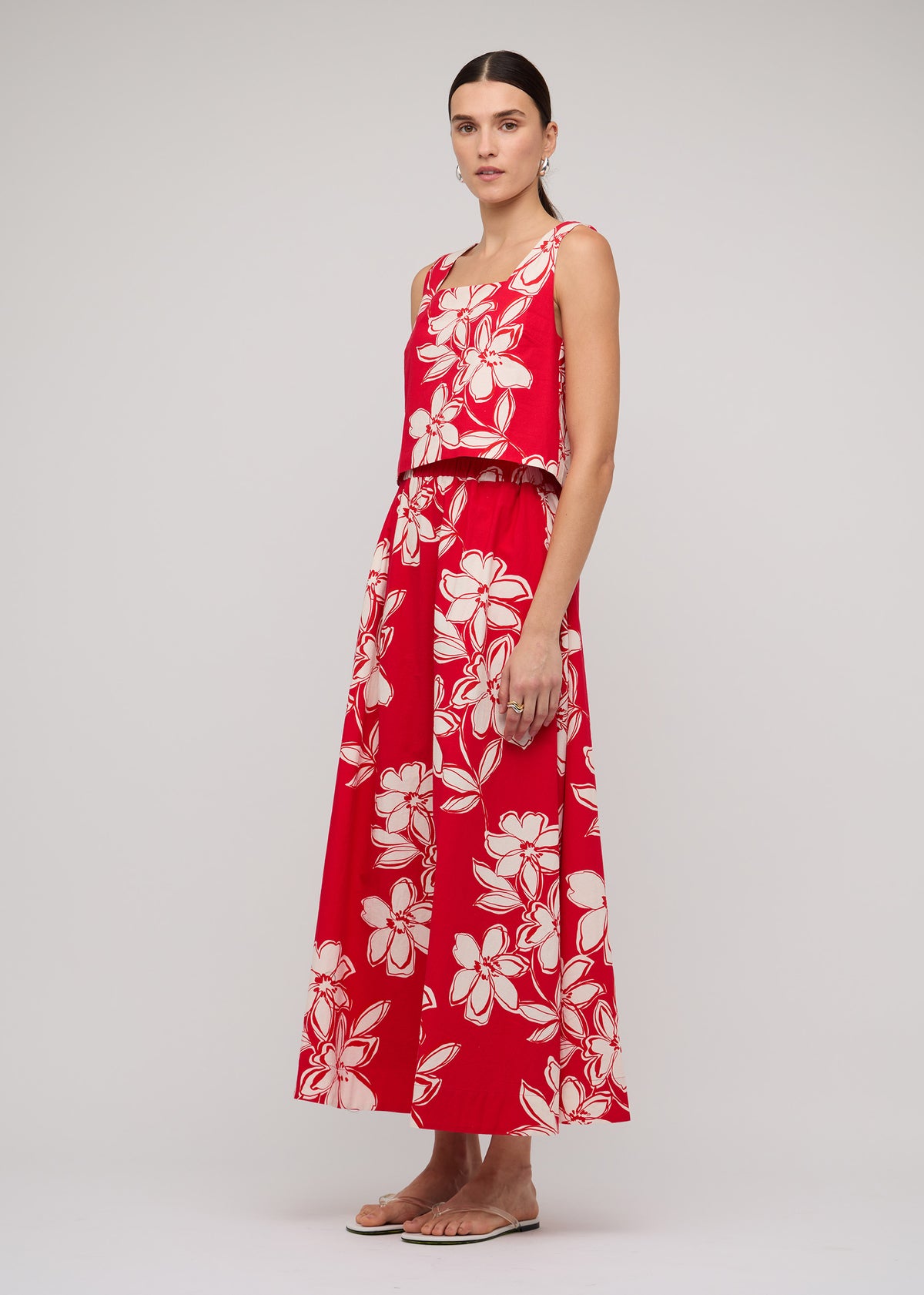 Model wearing Red and White Cotton Floral Crop Top with a red with white floral print and a square neckline, turned to the side.