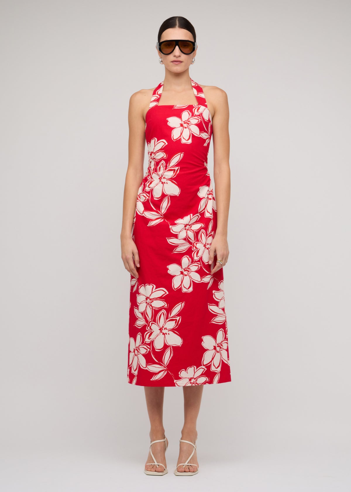 Model wearing Red and White Cotton Floral Halter-Neck Midi Dress with a red with white floral print.