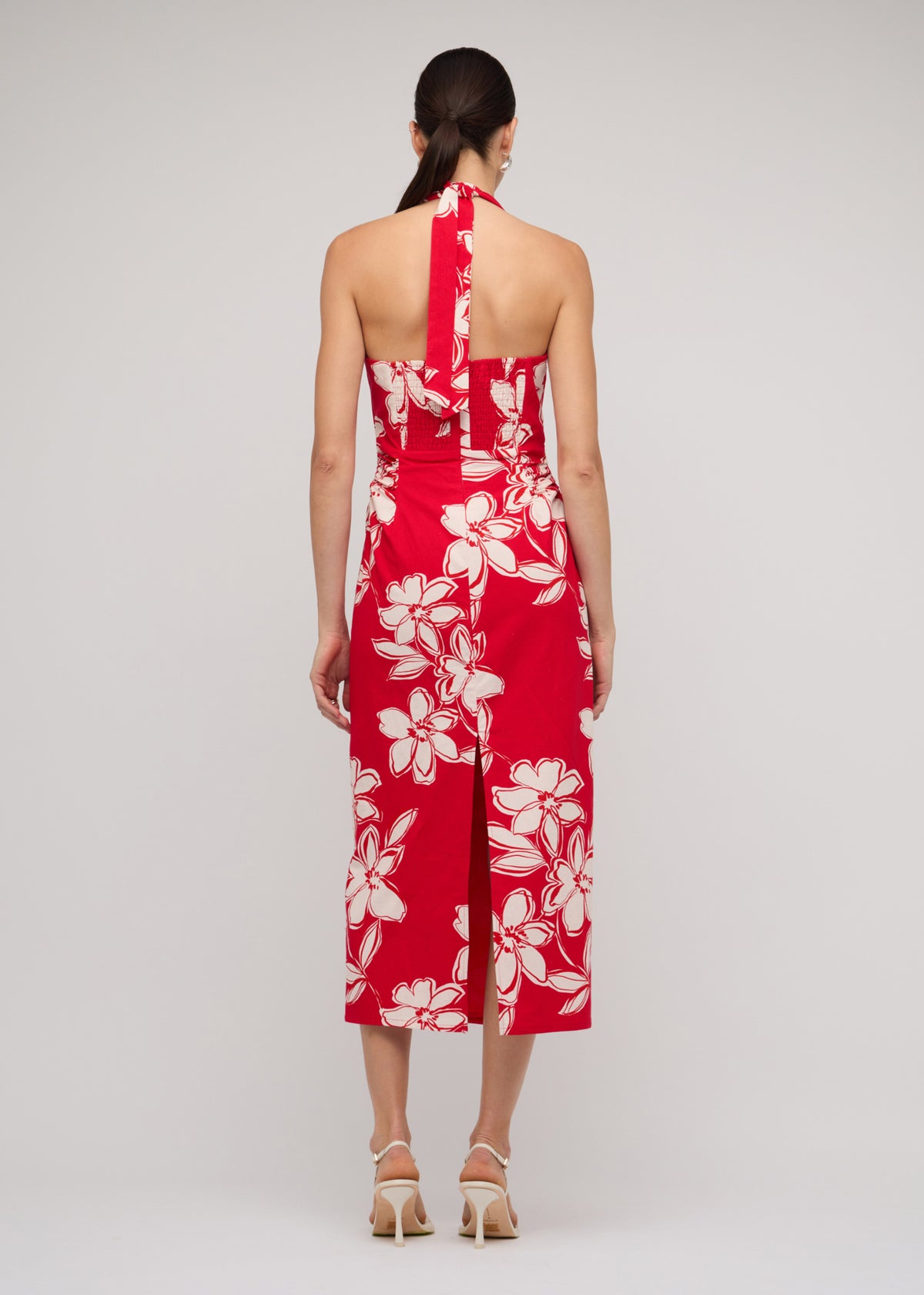 Back view of the Red and White Cotton Floral Halter-Neck Midi Dress with a red with white floral print.