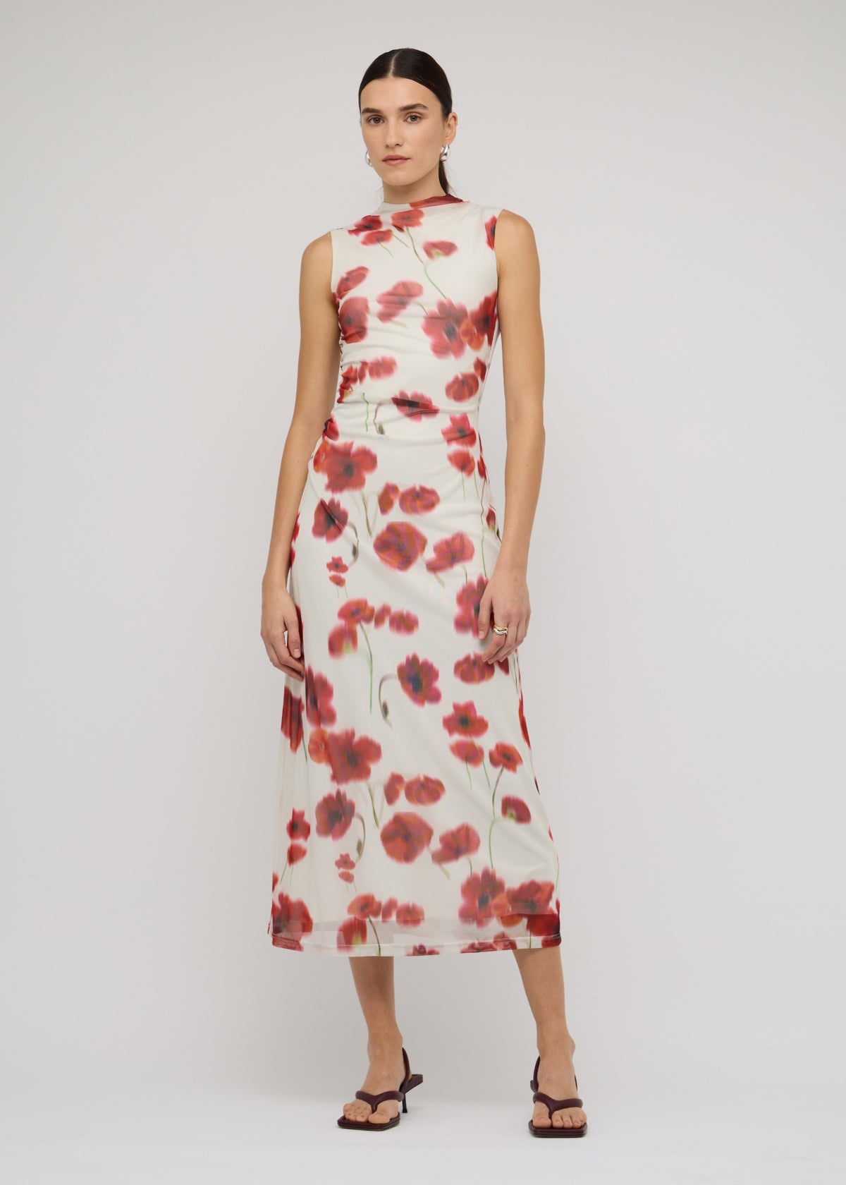 Model wearing Red and White Poppy Print Mesh Midi Dress with a blurred floral print and a sleeveless cut.