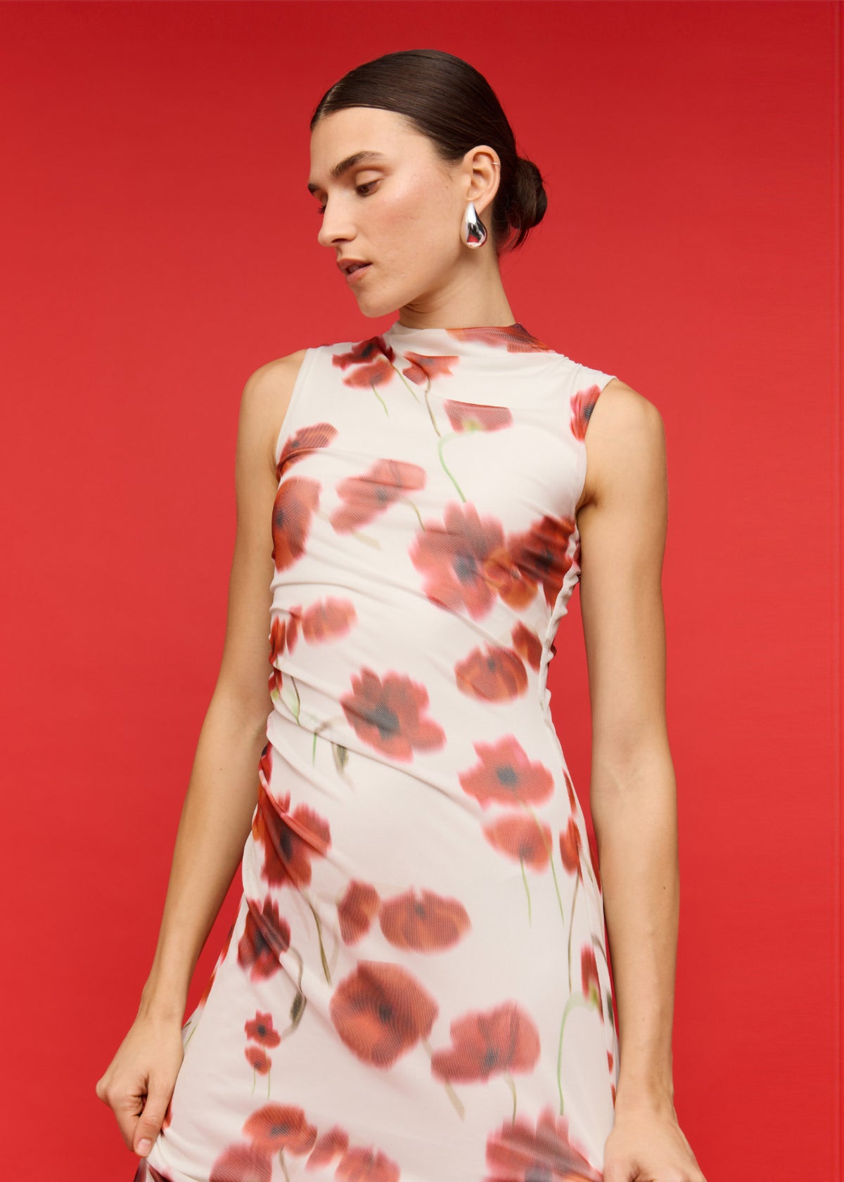 Model wearing Red and White Poppy Print Mesh Midi Dress with a midi length and a fully lined, turned to the side.