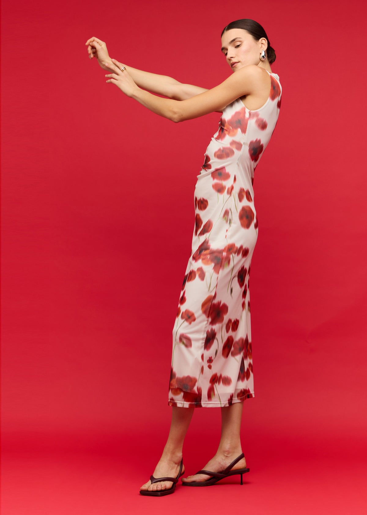 Side view of the Red and White Poppy Print Mesh Midi Dress, showing a figure-skimming silhouette and a blurred floral print.