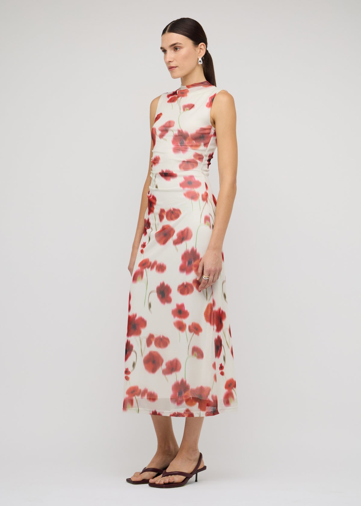 Model wearing Red and White Poppy Print Mesh Midi Dress, showing a sleeveless cut and a midi length.