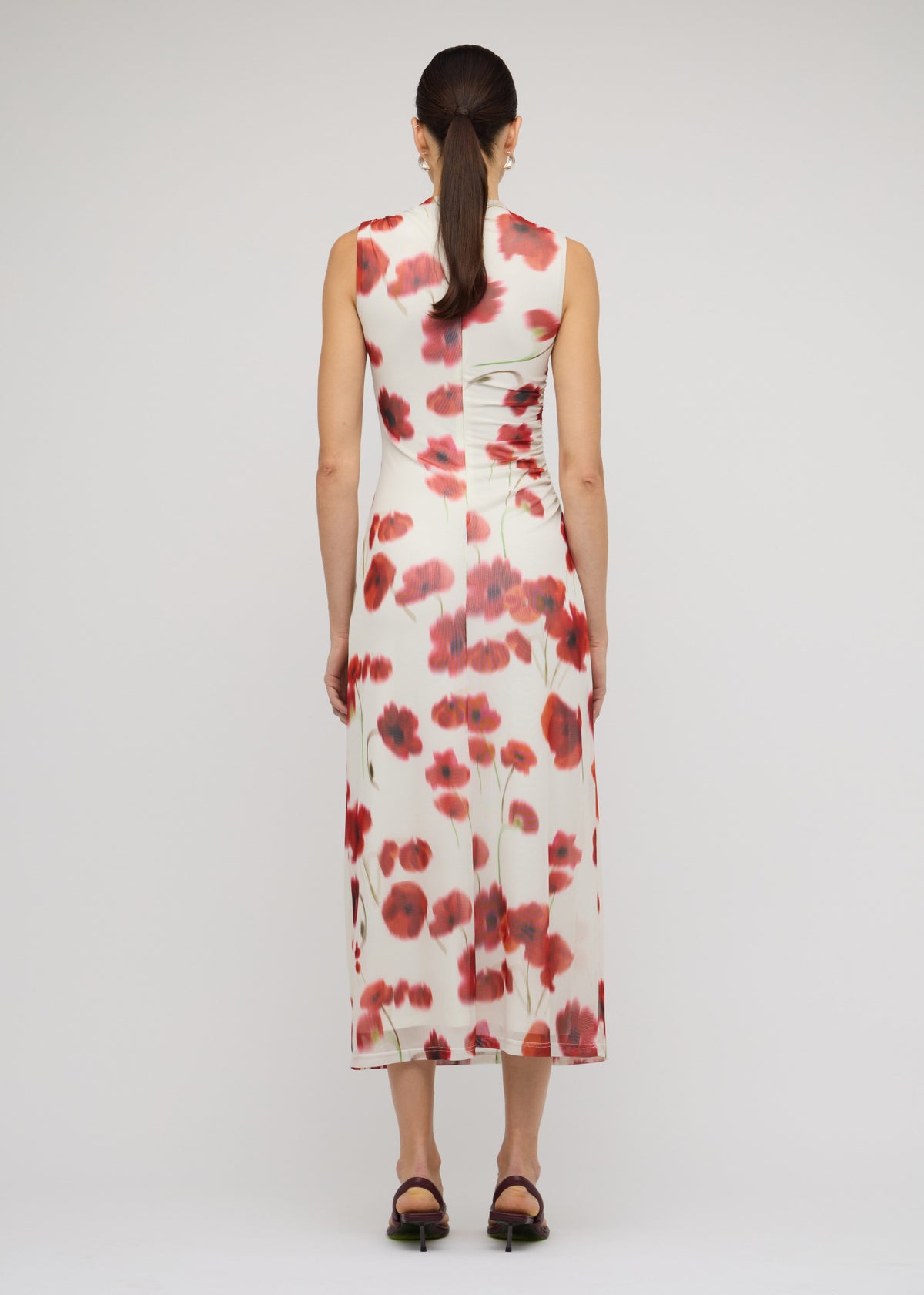 Back view of the Red and White Poppy Print Mesh Midi Dress with a blurred floral print and a sleeveless cut.