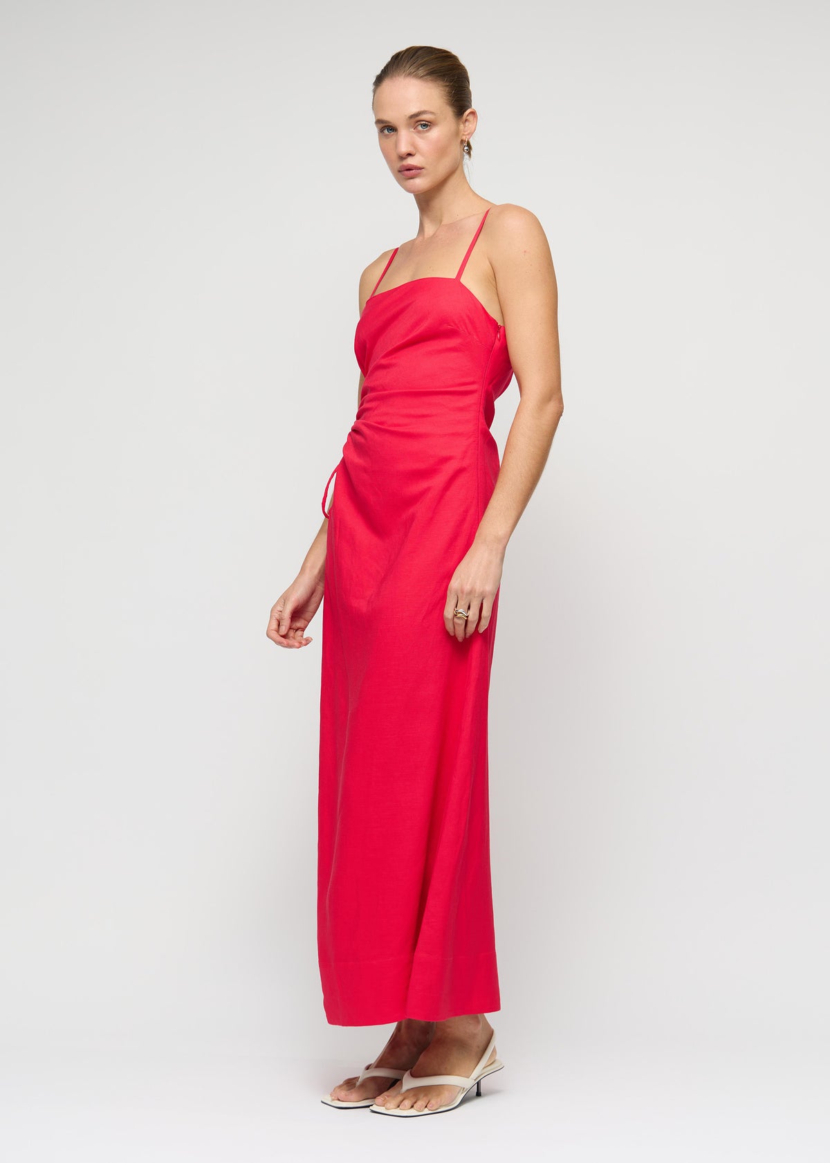 Model wearing Red Linen Blend Cut-Out Maxi Dress with a maxi length and a fully lined, turned to the side.