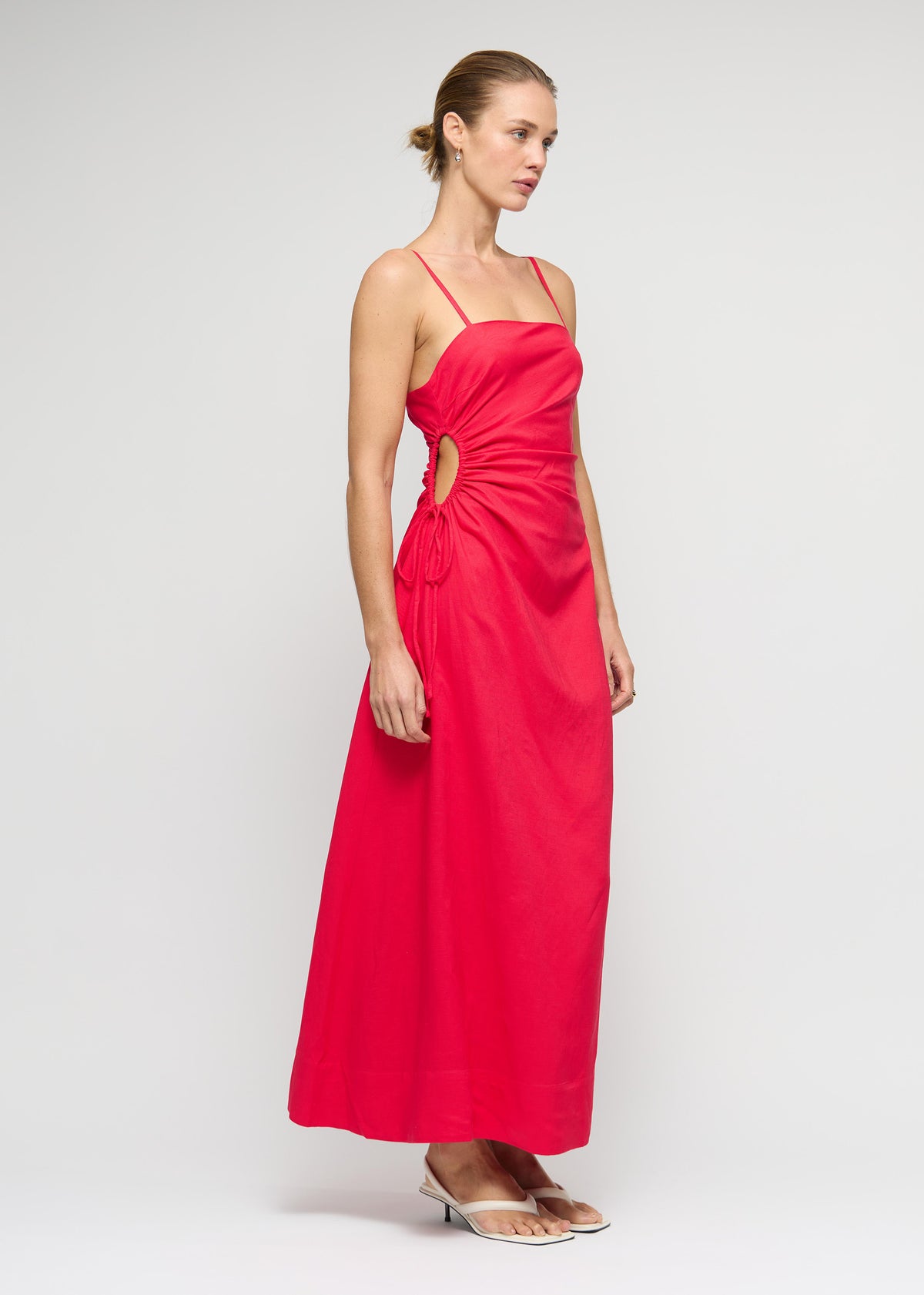 Angled view of the Red Linen Blend Cut-Out Maxi Dress with square neckline with thin straps.