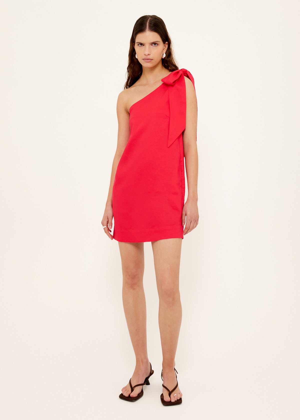 Model wearing Red Linen Blend One Shoulder Mini Dress with a one-shoulder neckline and a statement self-tie bow detail.