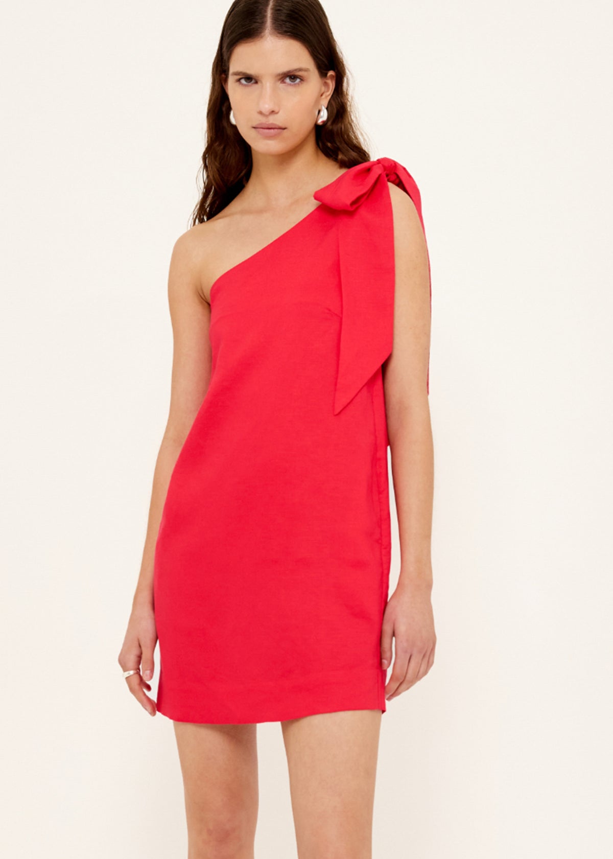Close-up of Red Linen Blend One Shoulder Mini Dress with a one-shoulder neckline and a statement self-tie bow detail.