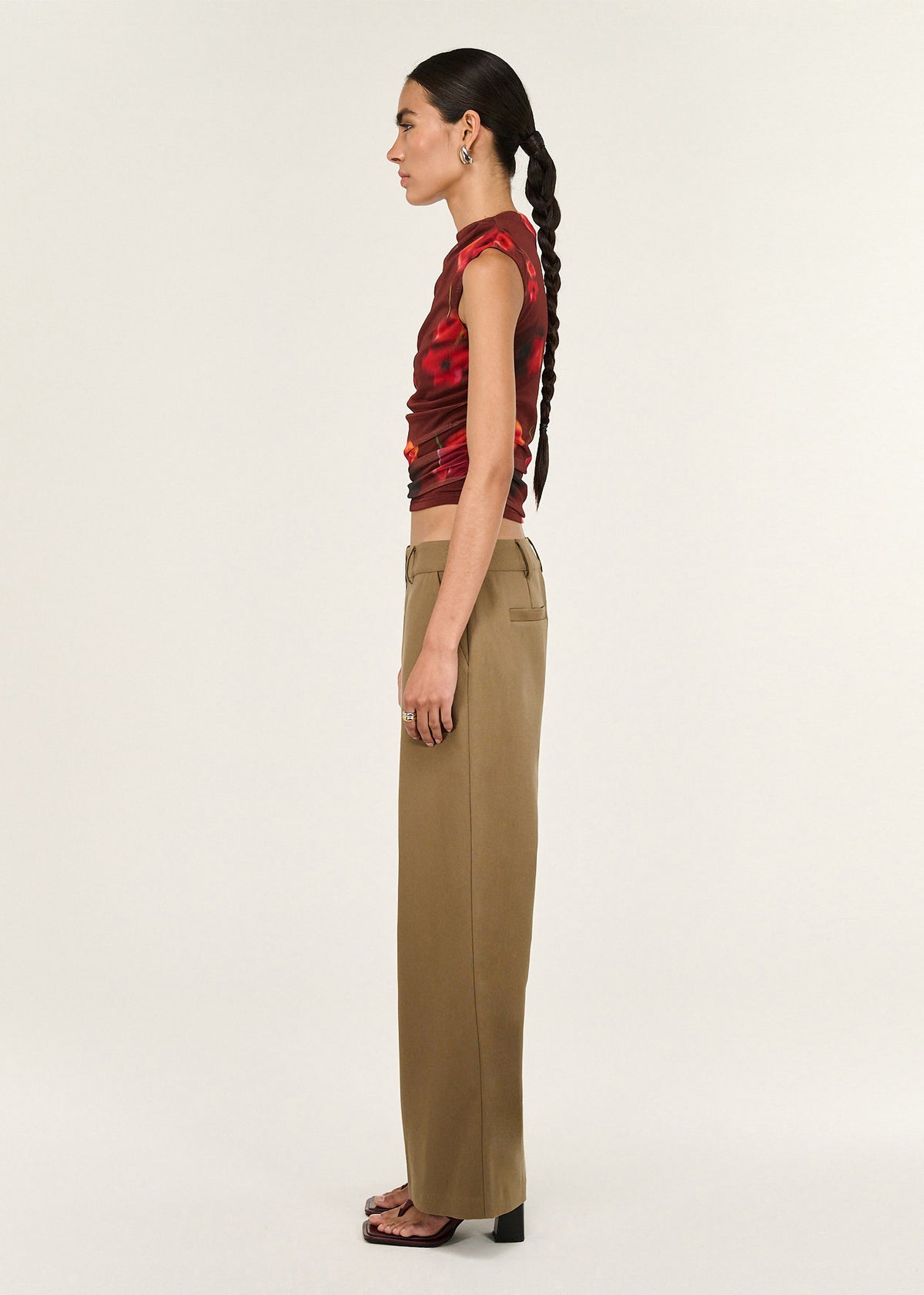 Side profile of the Red Poppy Print Mesh Tank with a stretch mesh fabrication and a high neckline silhouette.