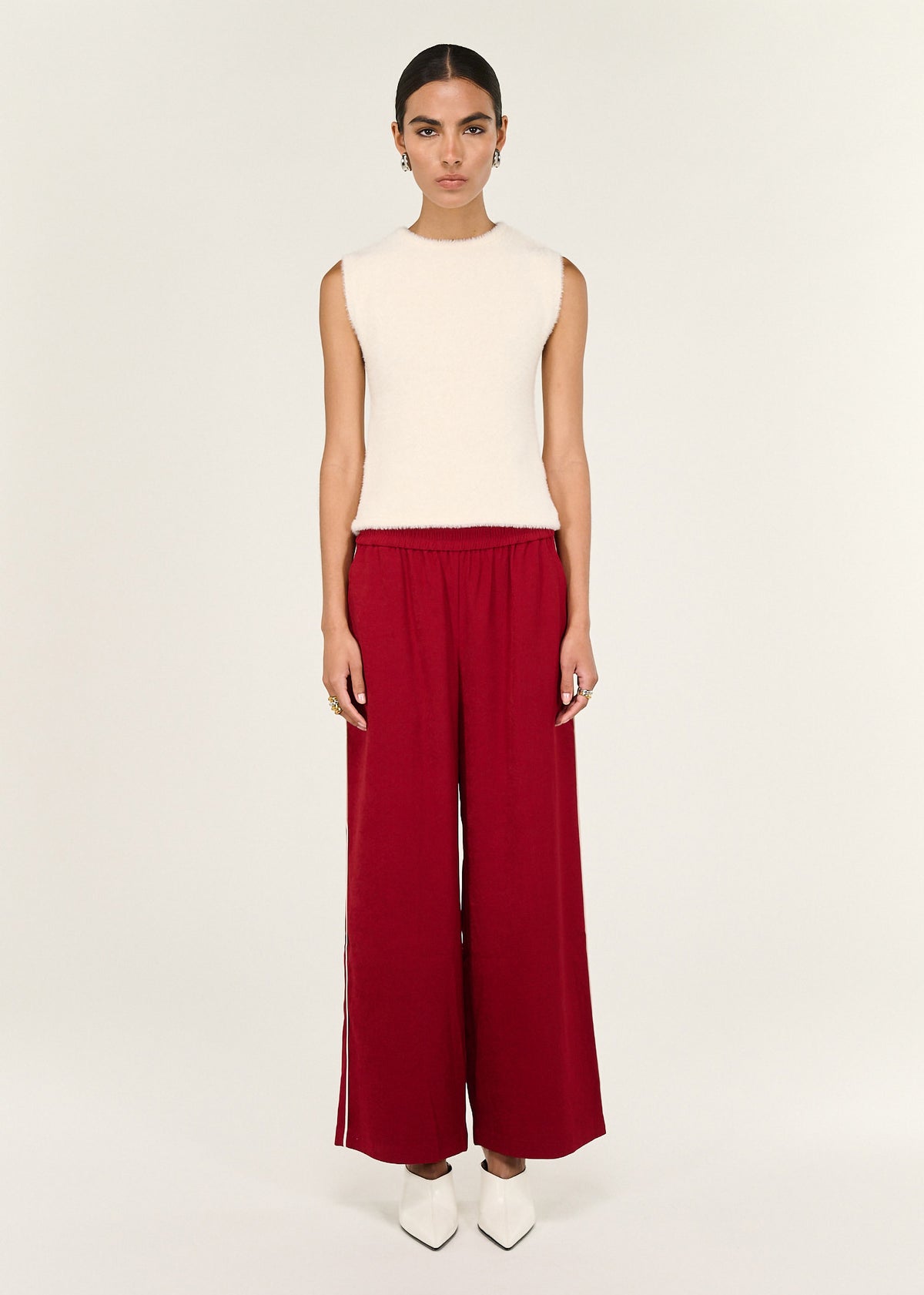 Model wearing Red Silky Wide Leg Pant with an elasticated waistband and a wide leg silhouette.