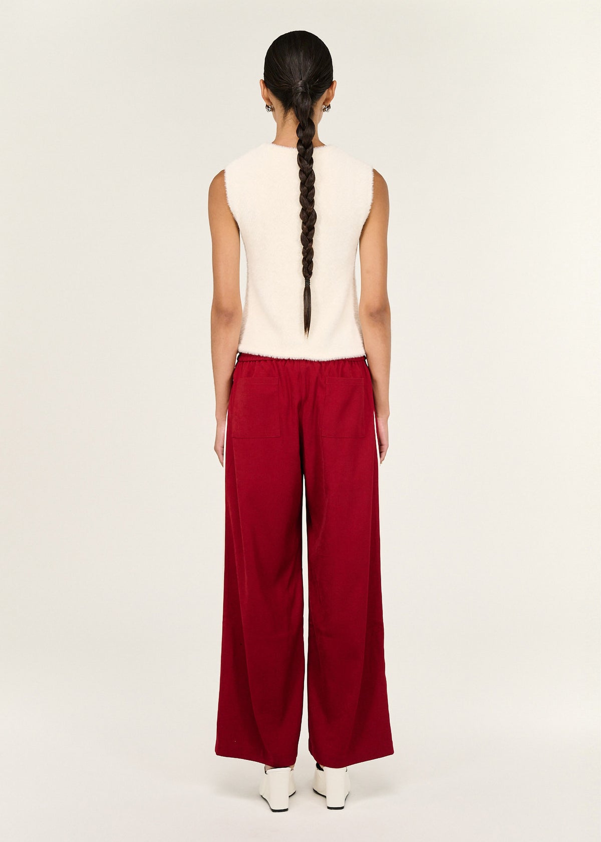 Back view of the Red Silky Wide Leg Pant with an elasticated waistband and a wide leg silhouette.