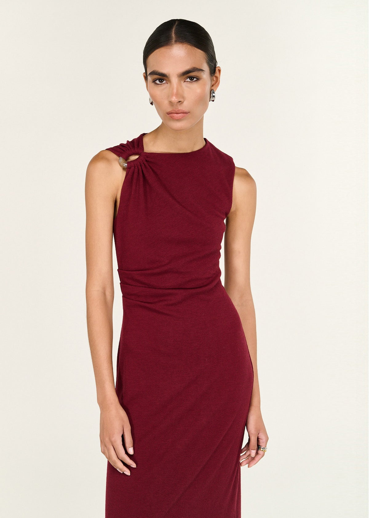 Close-up of the Red Stretch Jersey Midi Dress, showing a crew neckline and an asymmetric gathered shoulder with ring detail.