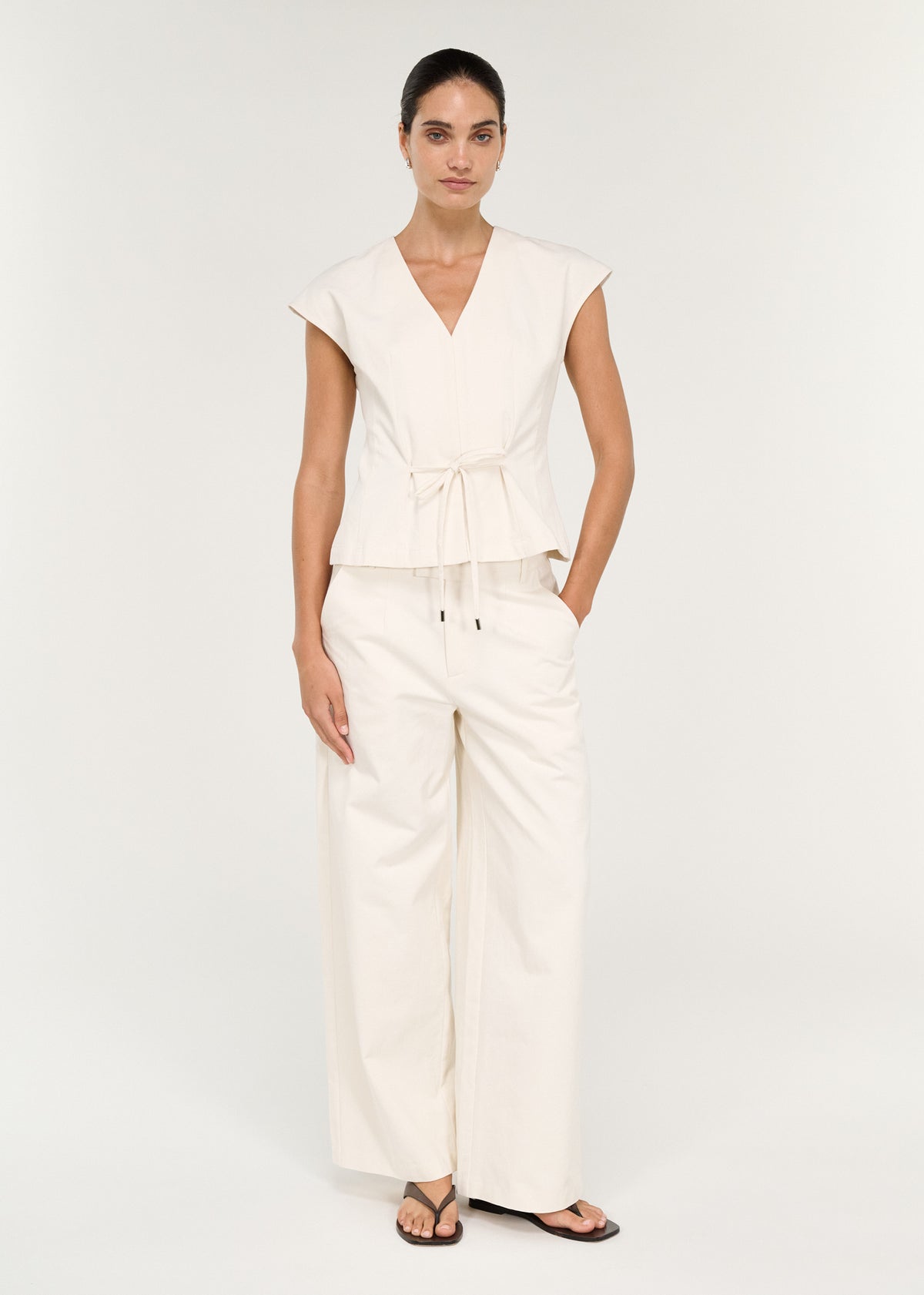 Model wearing Relaxed Cotton Wide Leg Pant in Cream, showing a tailored silhouette and a mid-rise waist.