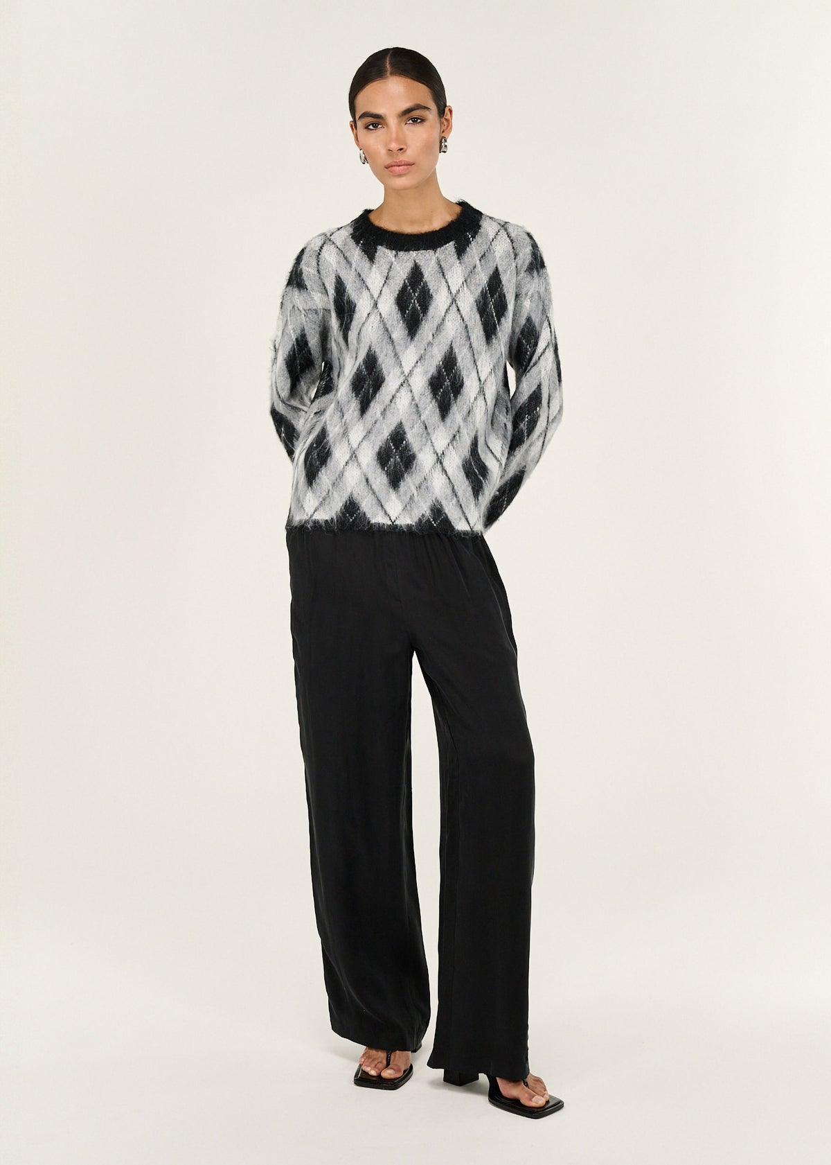 Model wearing Relaxed Fit Argyle Brushed Jumper with a relaxed fit and a crew neckline.