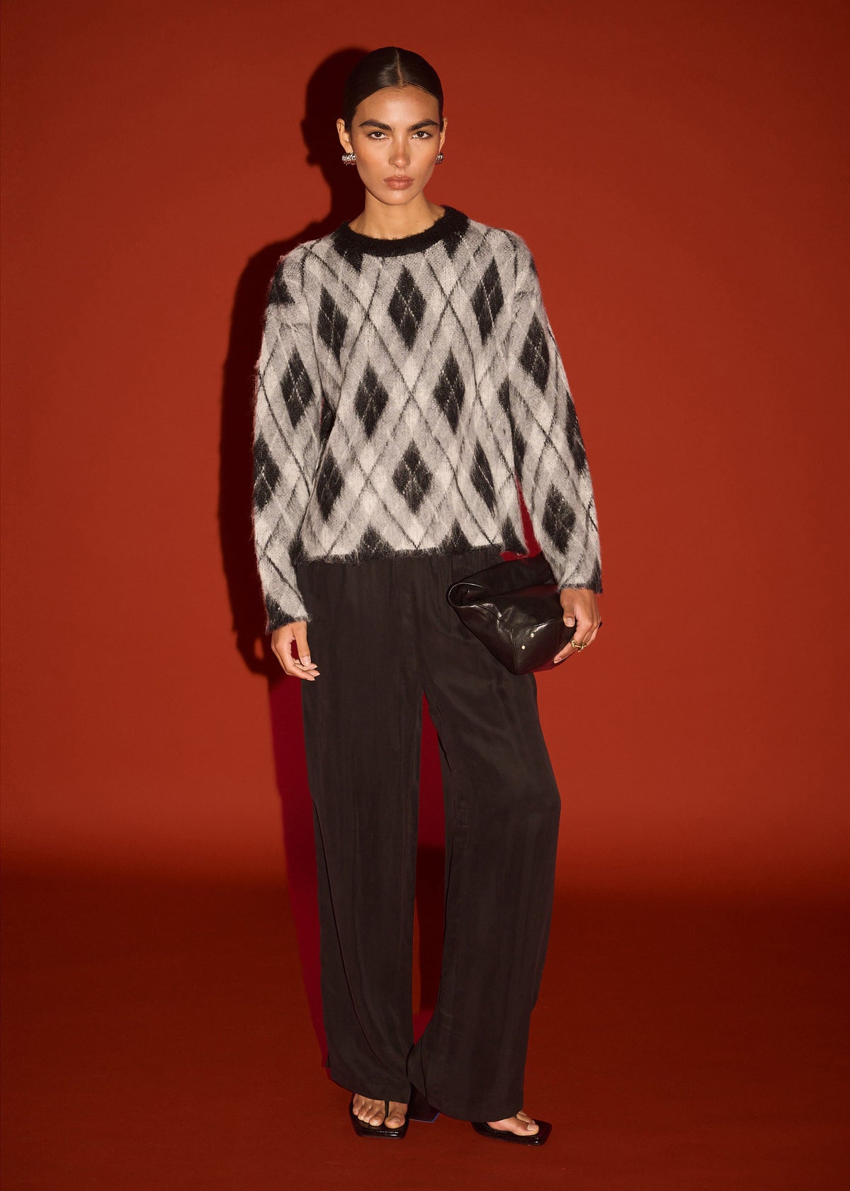 Model wearing Relaxed Fit Argyle Brushed Jumper, showing a soft brushed knit fabrication and an argyle pattern design.