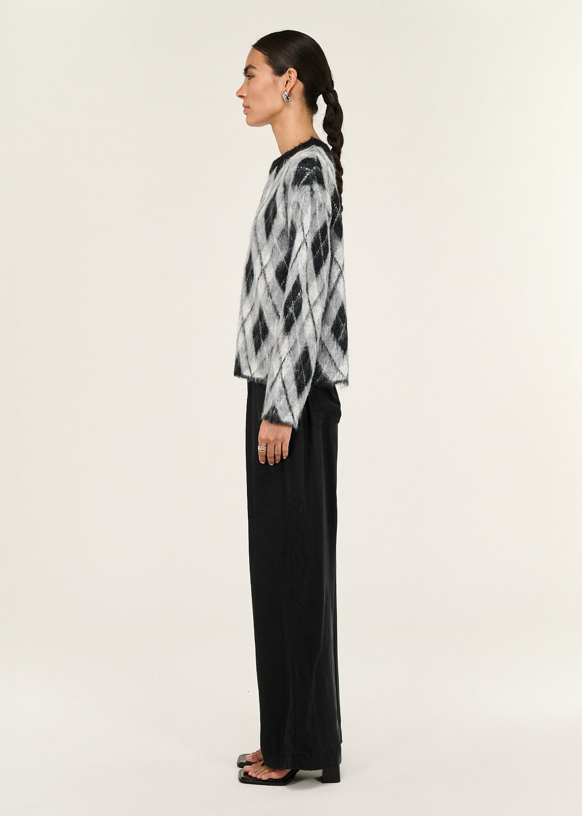 Side profile of the Relaxed Fit Argyle Brushed Jumper with a soft brushed knit fabrication and an argyle pattern design.