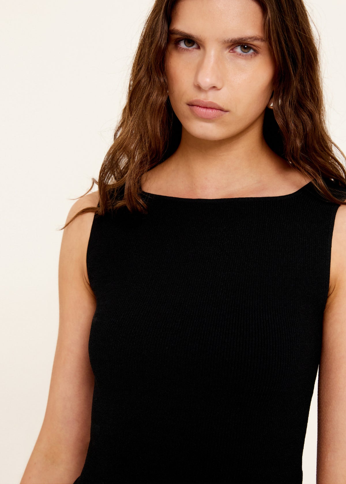 Close-up of the Reversible Black Knit Tank Top, showing a reversible neckline - scoop or boat neck and a fitted silhouette.
