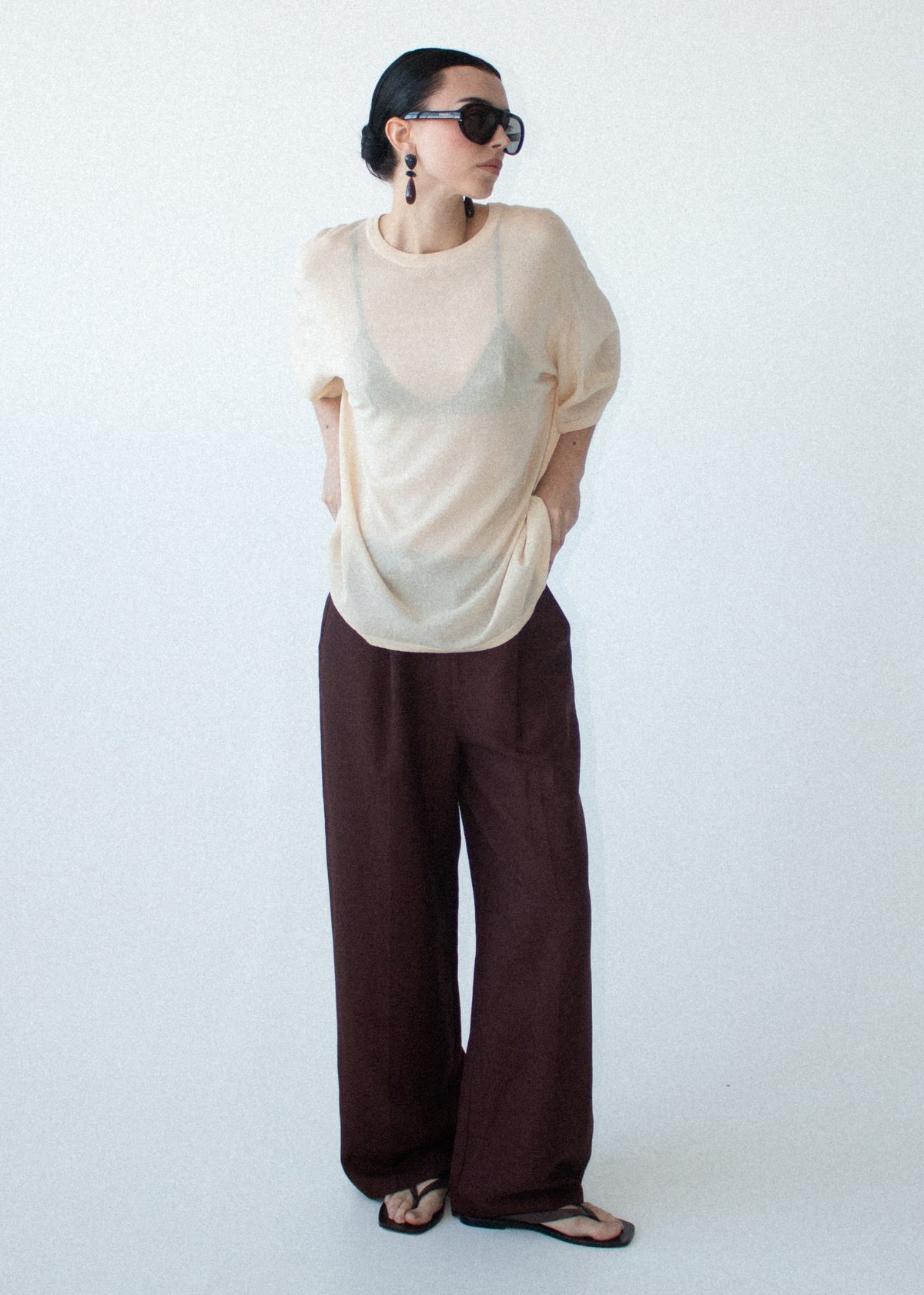 Model wearing Round Neck Oversized Knit Tee in Ecru with a round neckline and a lightweight knit fabrication.