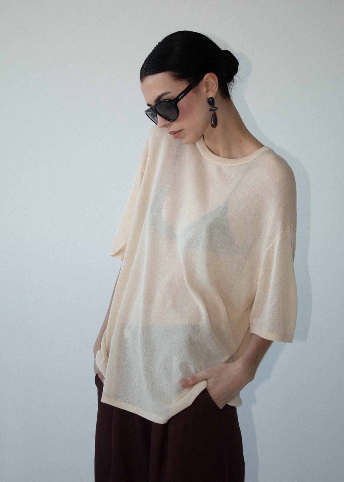 Close-up of the Round Neck Oversized Knit Tee in Ecru, showing a round neckline and dropped shoulders.