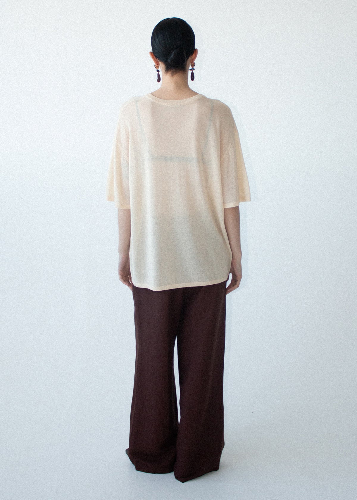 Back view of the Round Neck Oversized Knit Tee in Ecru with a lightweight knit fabrication and a round neckline.