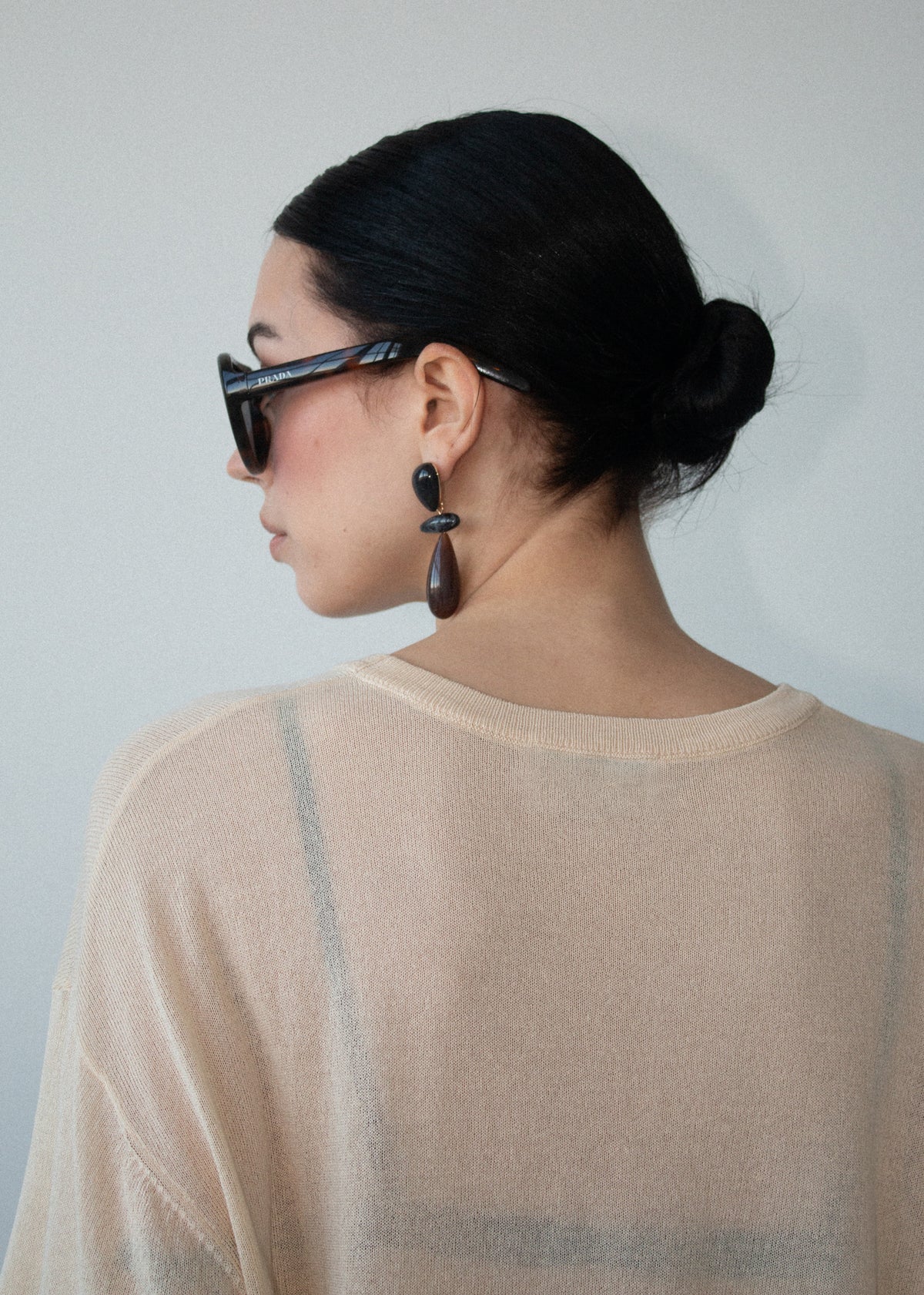 Close-up detail of the Round Neck Oversized Knit Tee in Ecru, showing shoulder and knit.