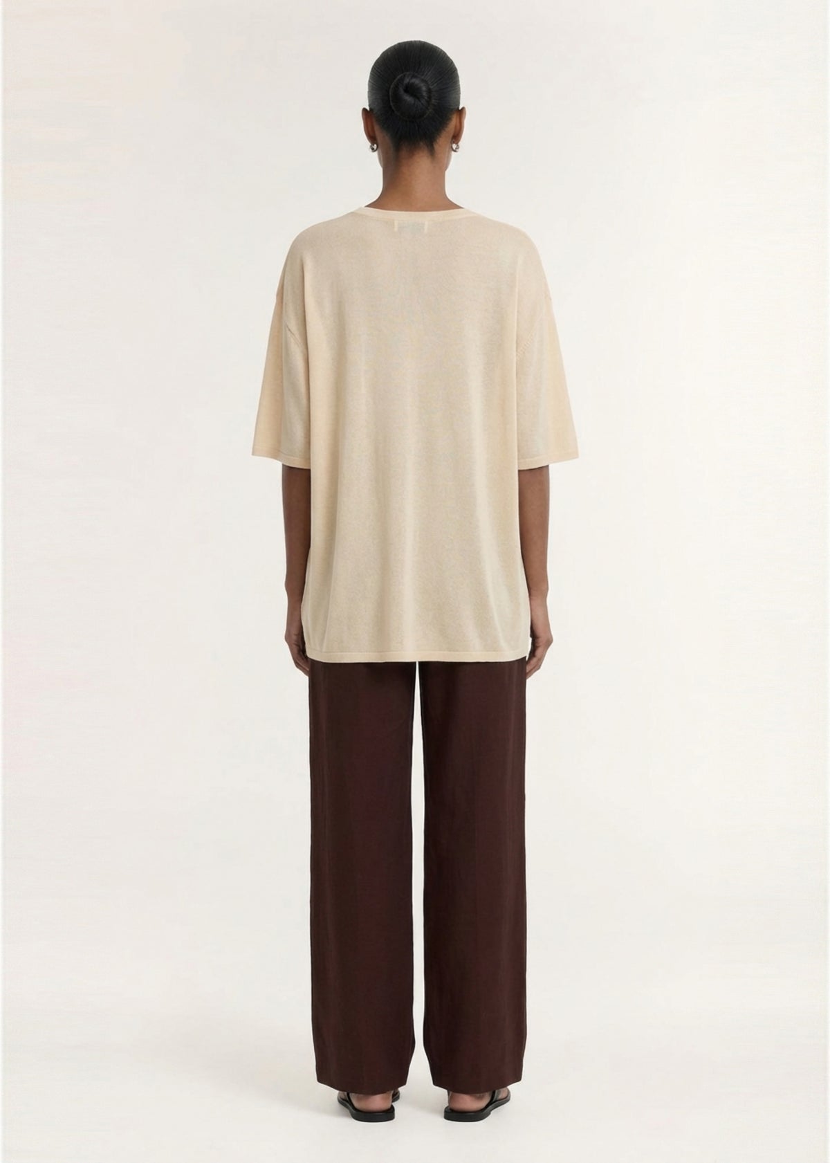 Back view of the Round Neck Oversized Knit Tee in Ecru, showing a lightweight knit fabrication and a round neckline.