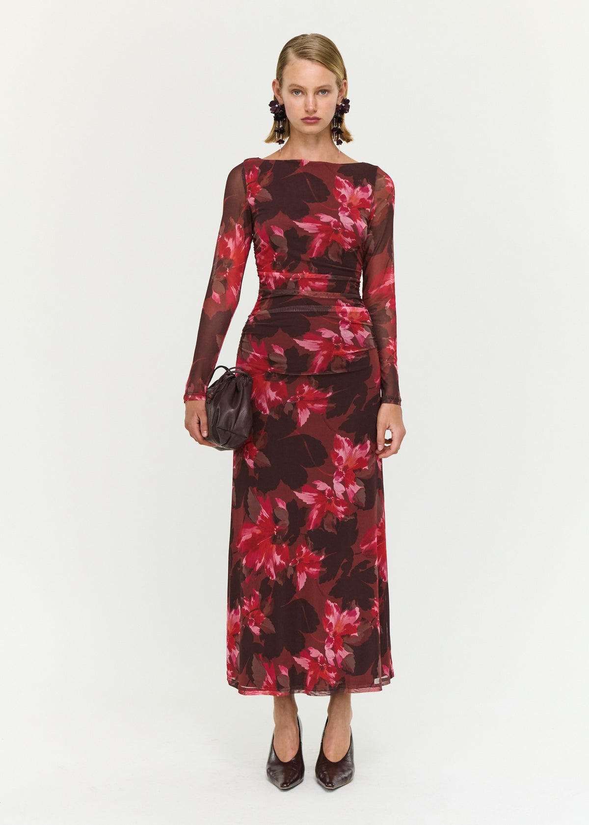Model wearing Ruched Pink Floral Mesh Midi Dress, showing a ruched waist detailing and a fitted silhouette.