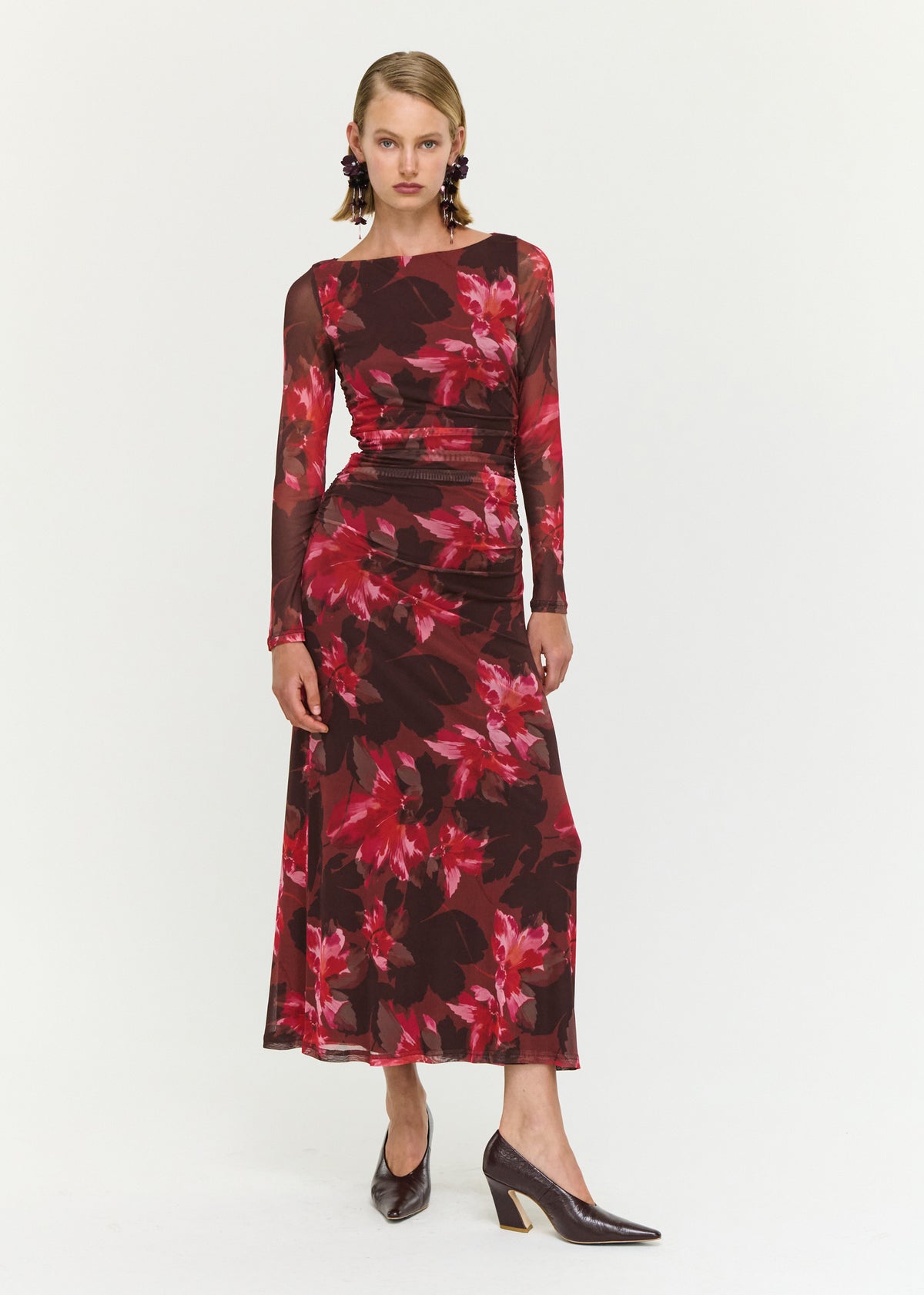 Model wearing Ruched Pink Floral Mesh Midi Dress with a midi length and a lined body.