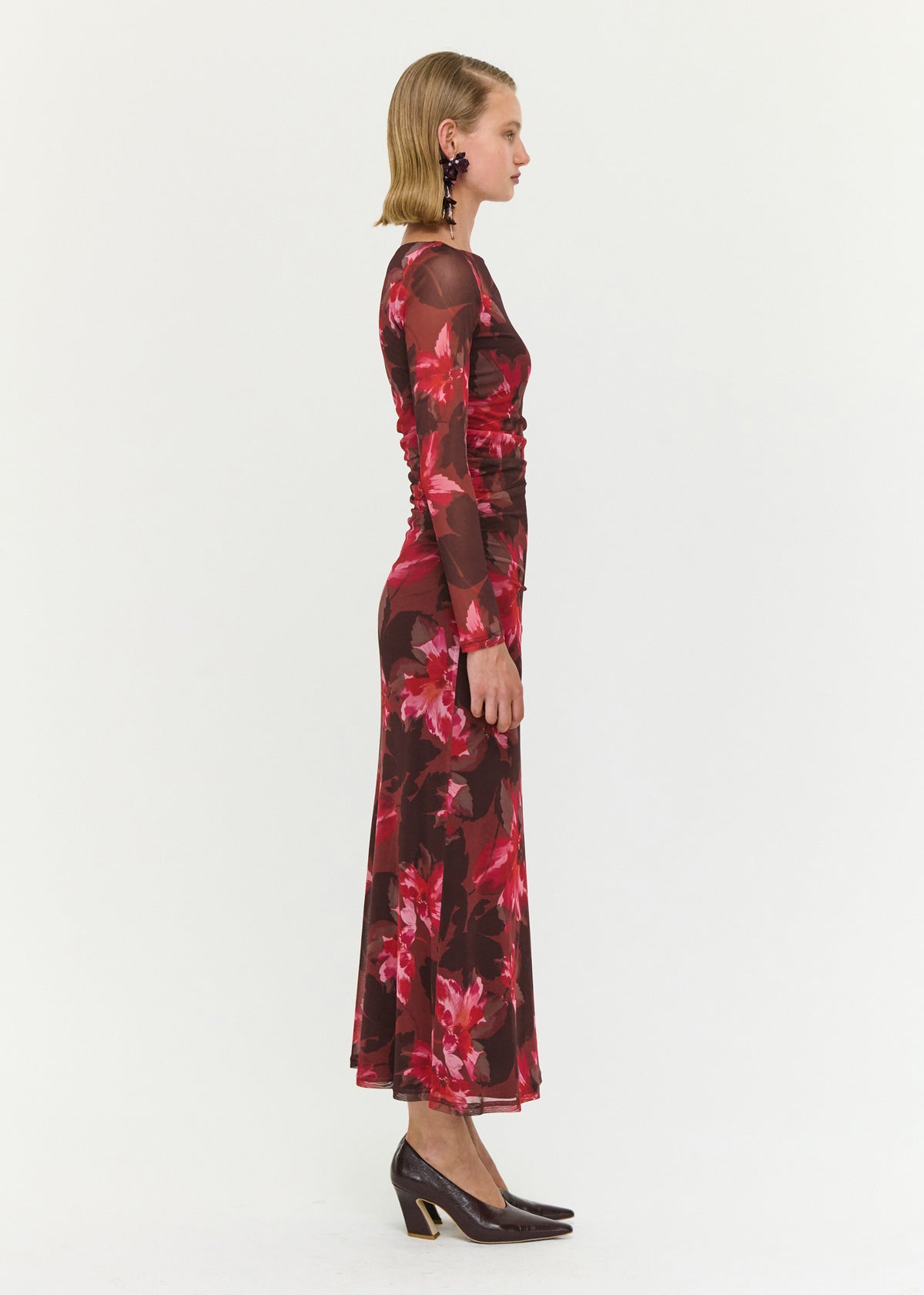 Side view of the Ruched Pink Floral Mesh Midi Dress, showing a sheer mesh fabrication and an oversized floral print.
