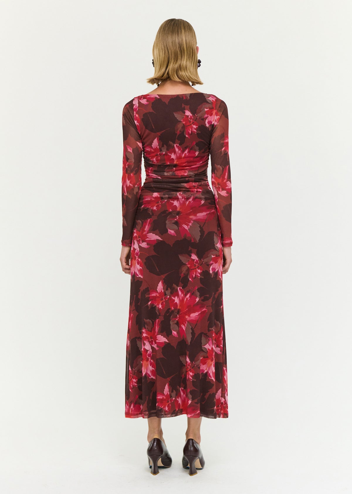 Back view of the Ruched Pink Floral Mesh Midi Dress with a sheer mesh fabrication and an oversized floral print.