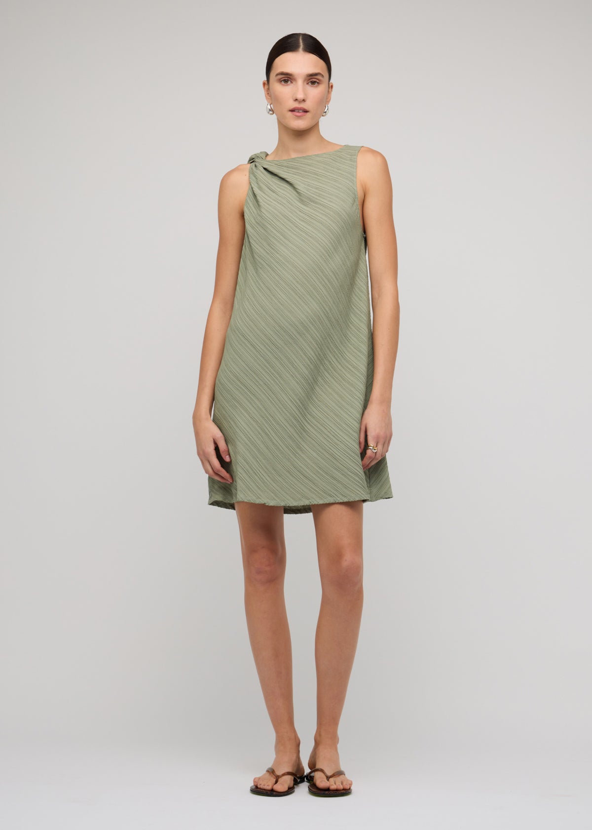Model wearing Sage Green Mini Dress With Tie Waist, showing a removable waist tie and a mini length.