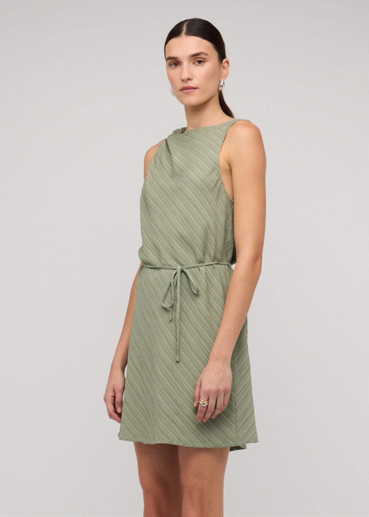 Close-up of the Sage Green Mini Dress With Tie Waist, showing a sleeveless cut and a removable waist tie.