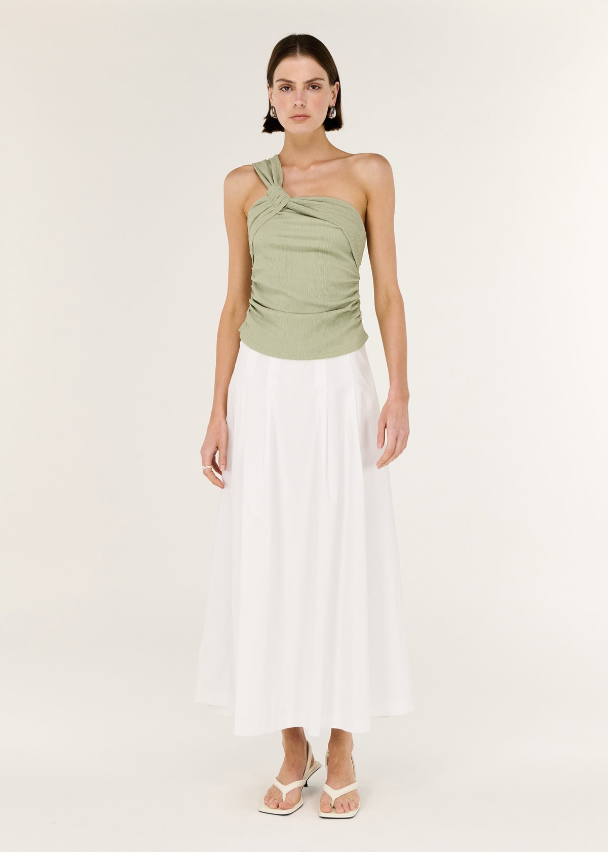 Model wearing Sage One Shoulder Knotted Top with a ruched body and a slim silhouette.
